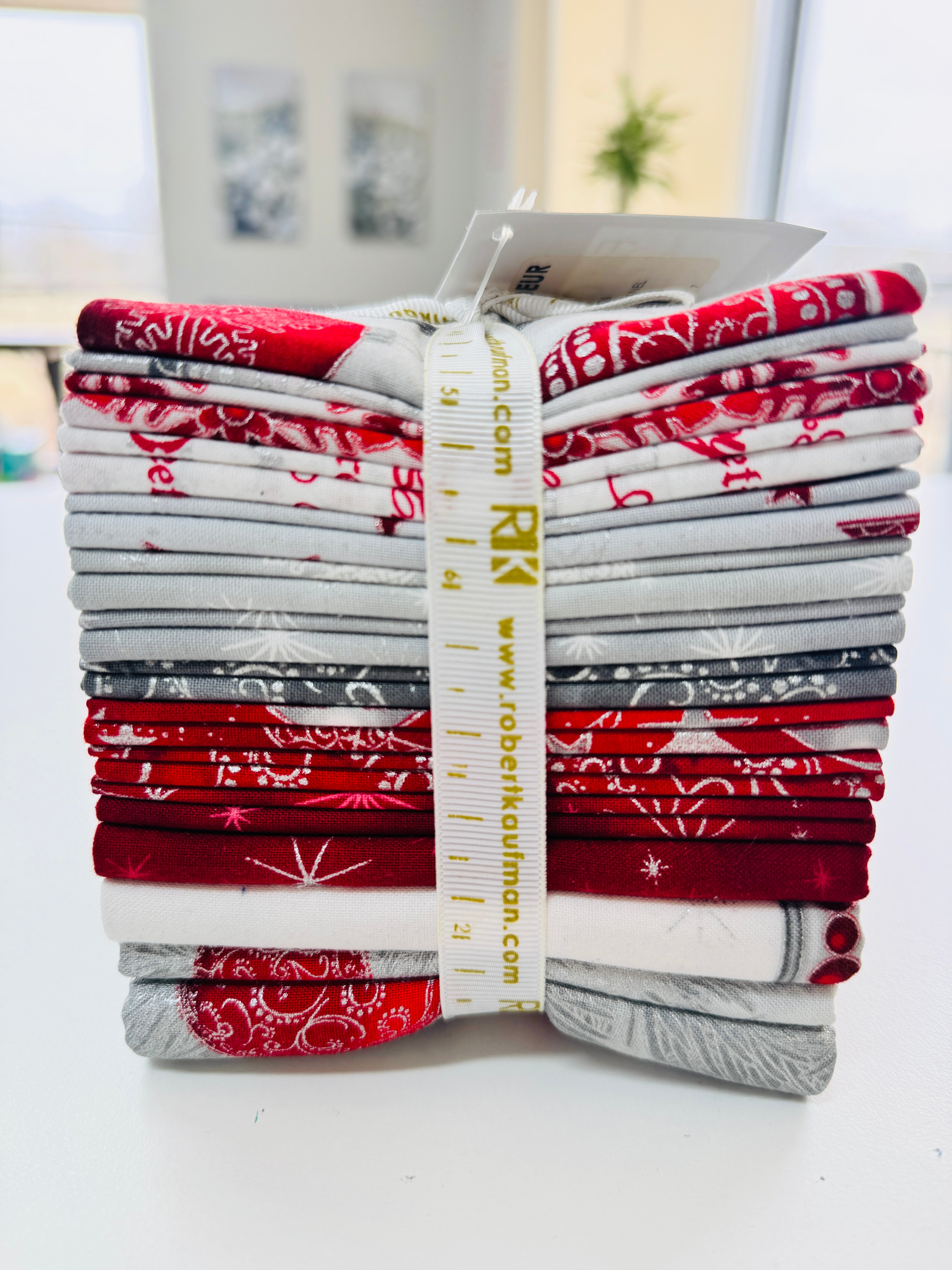 Winter’s Grandeur winter colorstory fat quarter bundle with red, gray, and white holiday quilting cotton fabrics