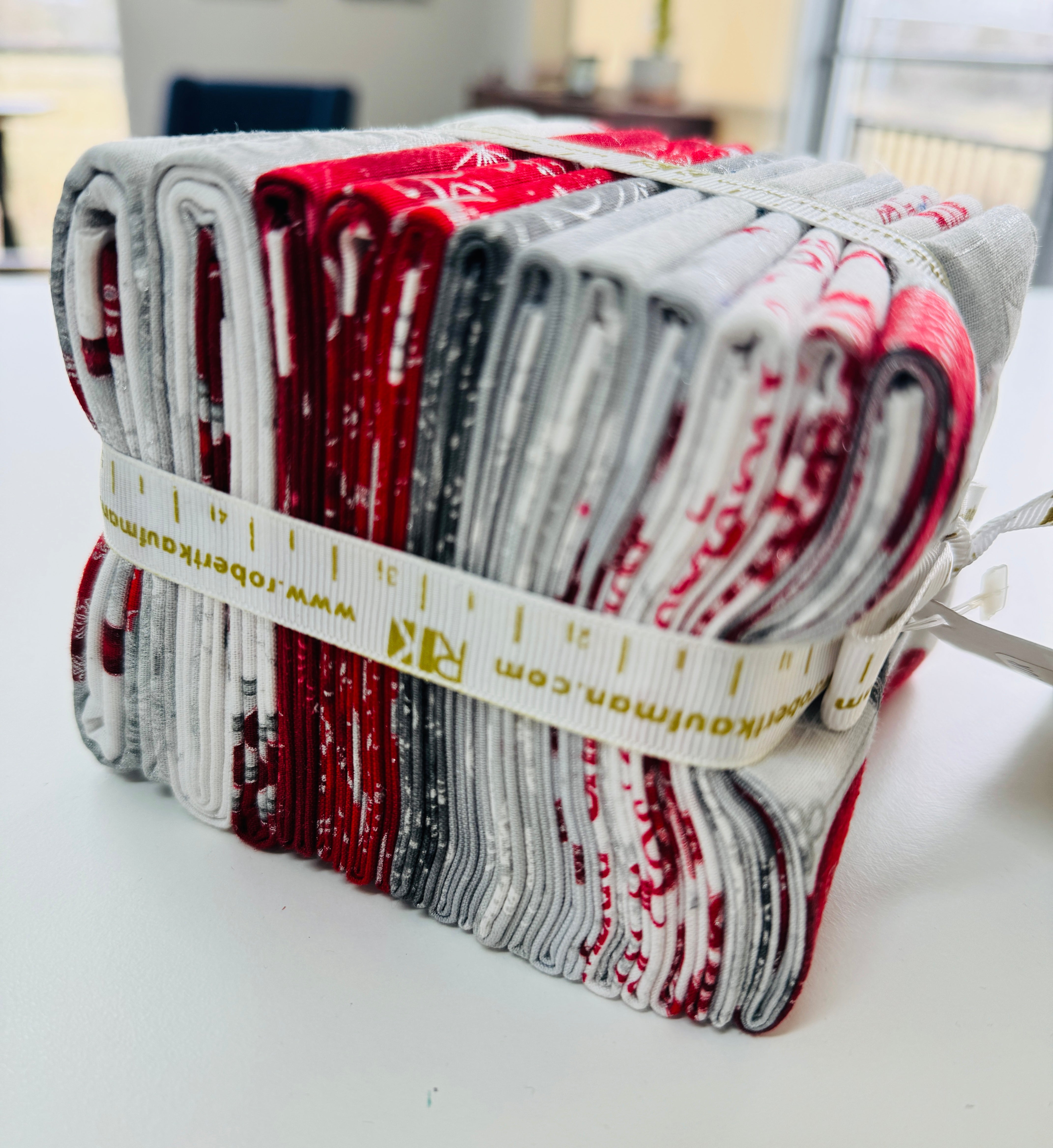 Winter’s Grandeur winter colorstory fat quarter bundle with red, gray, and white holiday quilting cotton fabrics