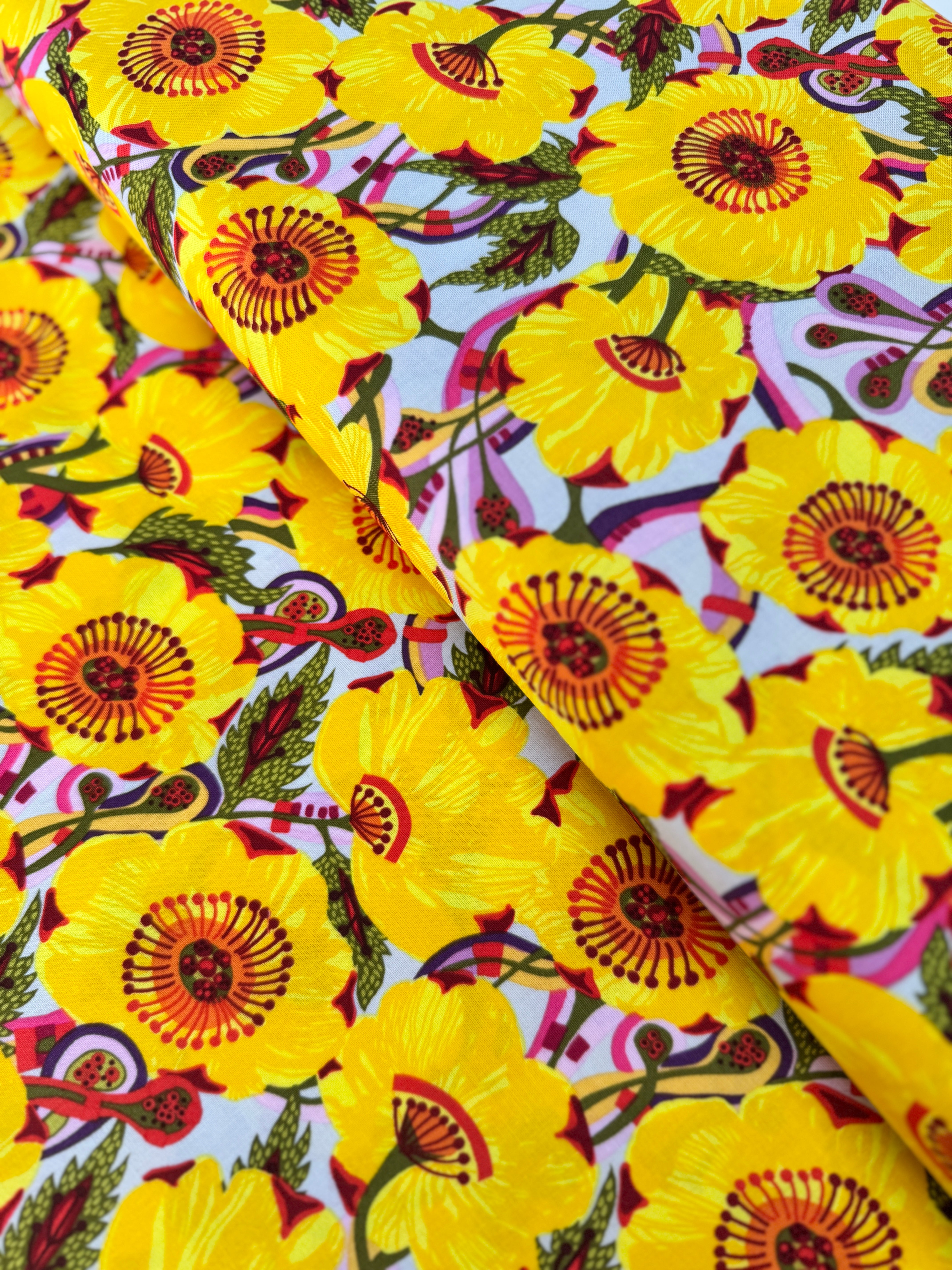 Sunshine Bloom Yellow floral fabric with bright golden flowers and red centers.