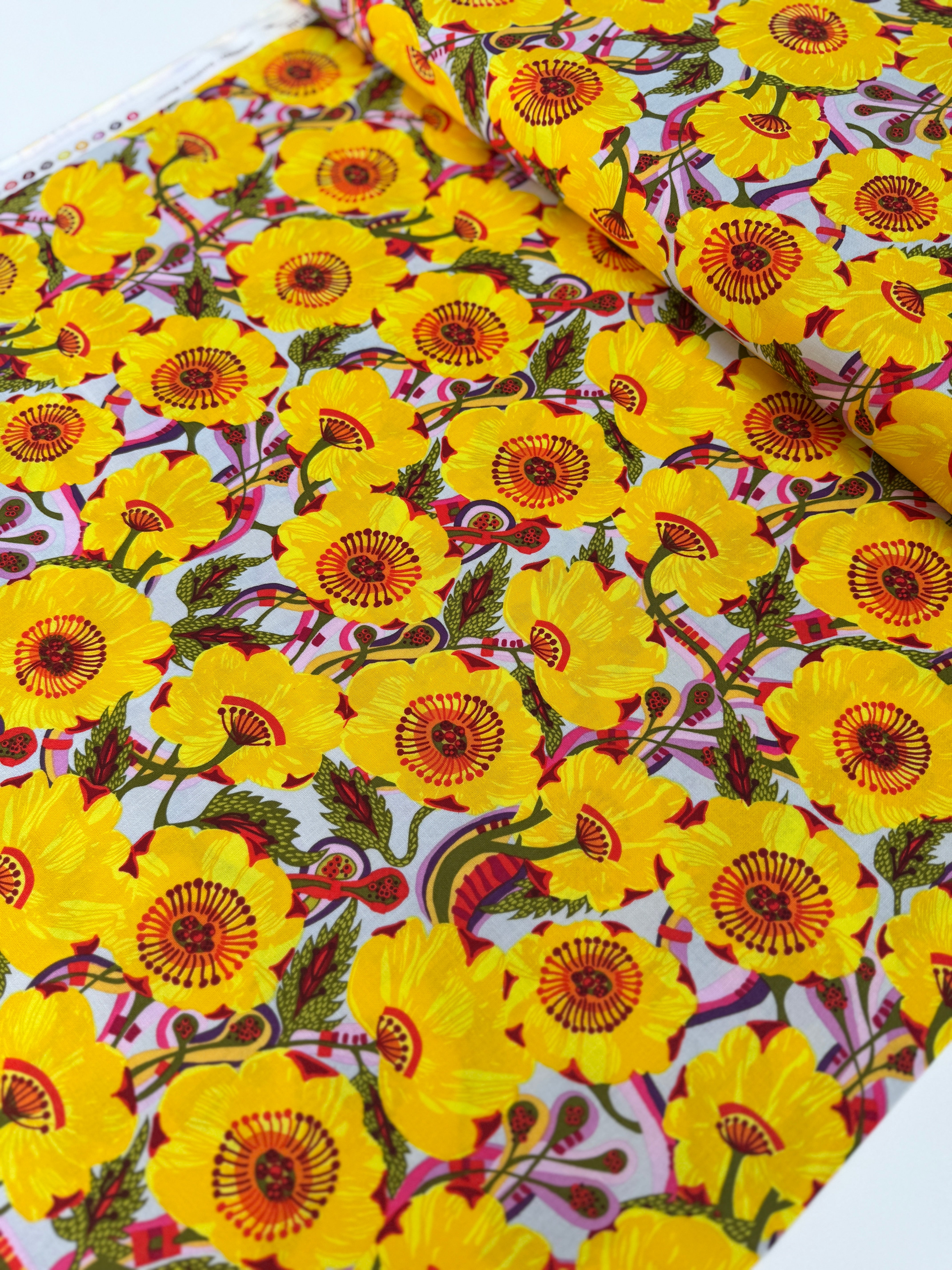 Sunshine Bloom Yellow floral fabric with bright golden flowers and red centers.