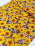 Sunshine Bloom Yellow floral fabric with bright golden flowers and red centers.