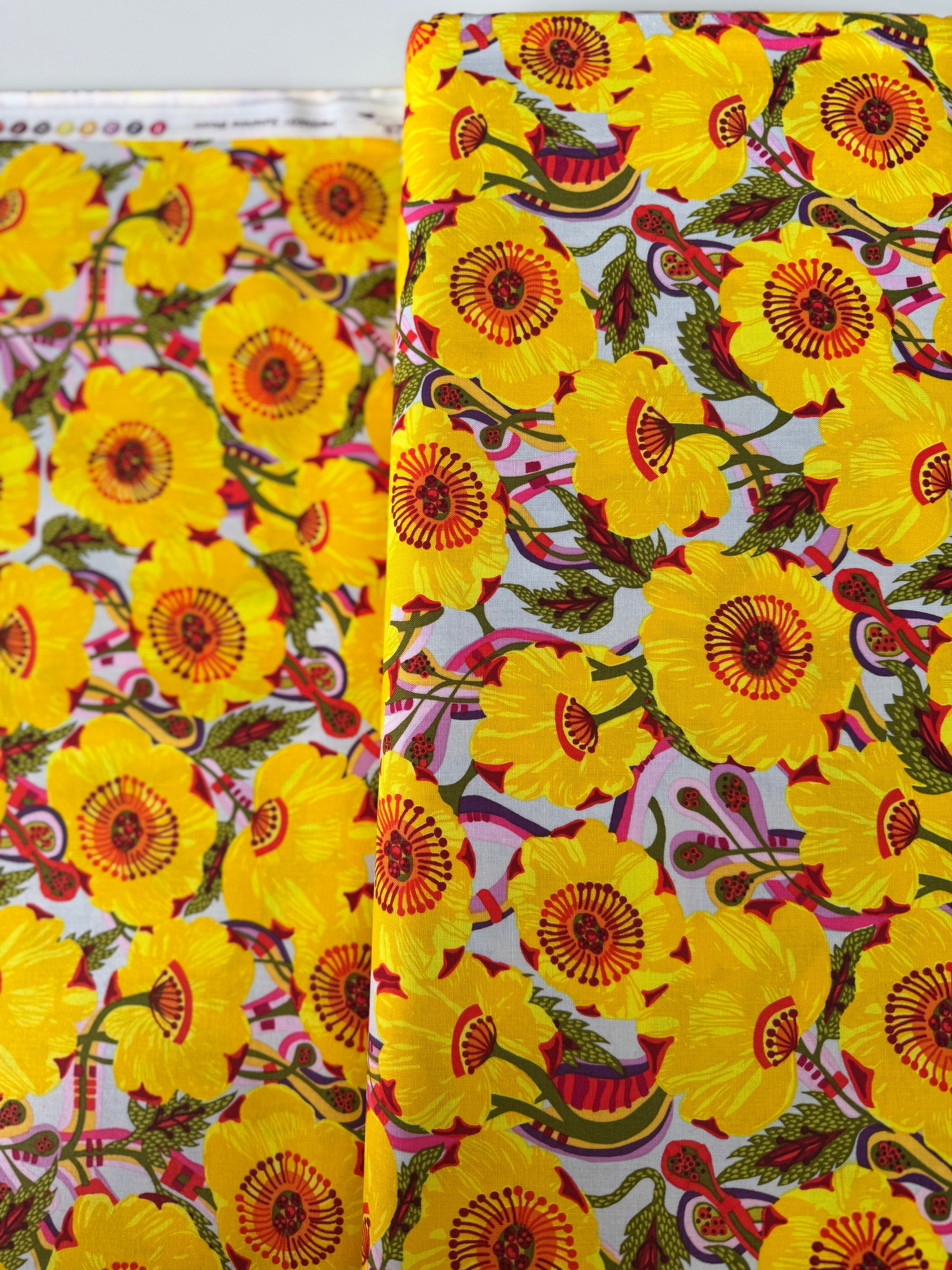 Sunshine Bloom Yellow floral fabric with bright golden flowers and red centers.