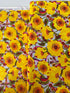 Sunshine Bloom Yellow floral fabric with bright golden flowers and red centers.