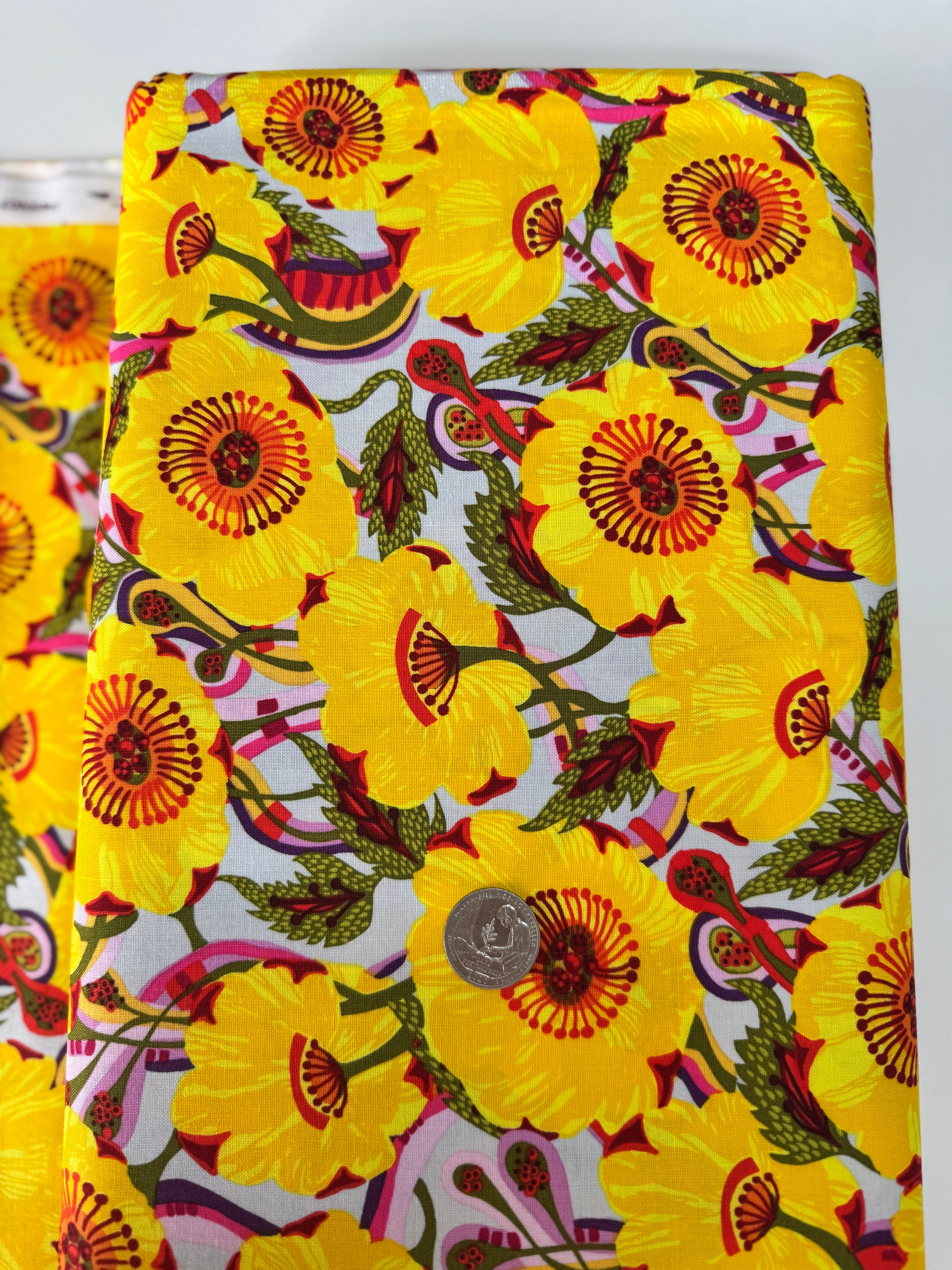 Sunshine Bloom Yellow floral fabric with bright golden flowers and red centers.