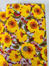 Sunshine Bloom Yellow floral fabric with bright golden flowers and red centers.