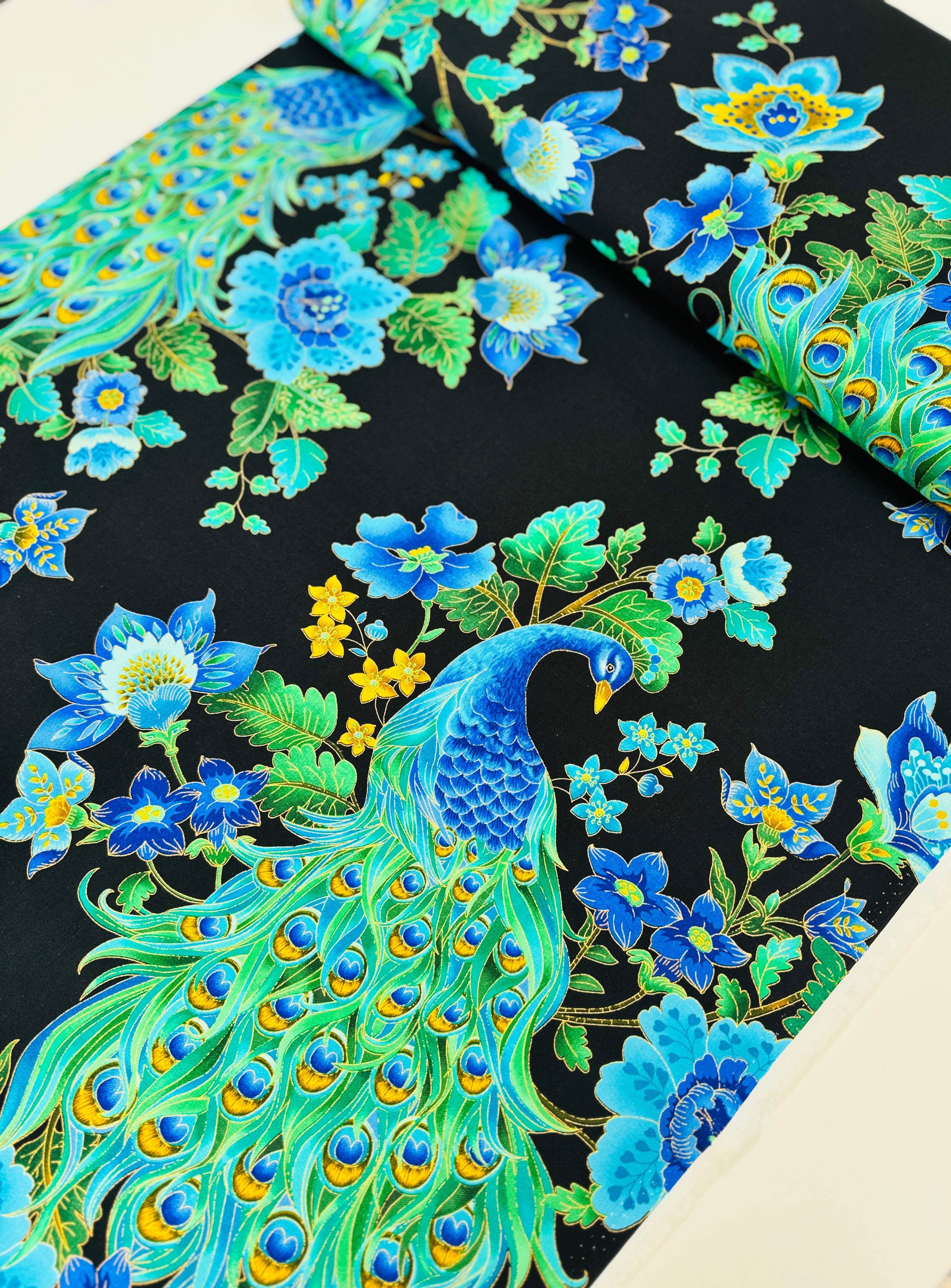 Peacock metallic cotton fabric on black background with gold accents by Timeless Treasures