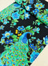Peacock metallic cotton fabric on black background with gold accents by Timeless Treasures
