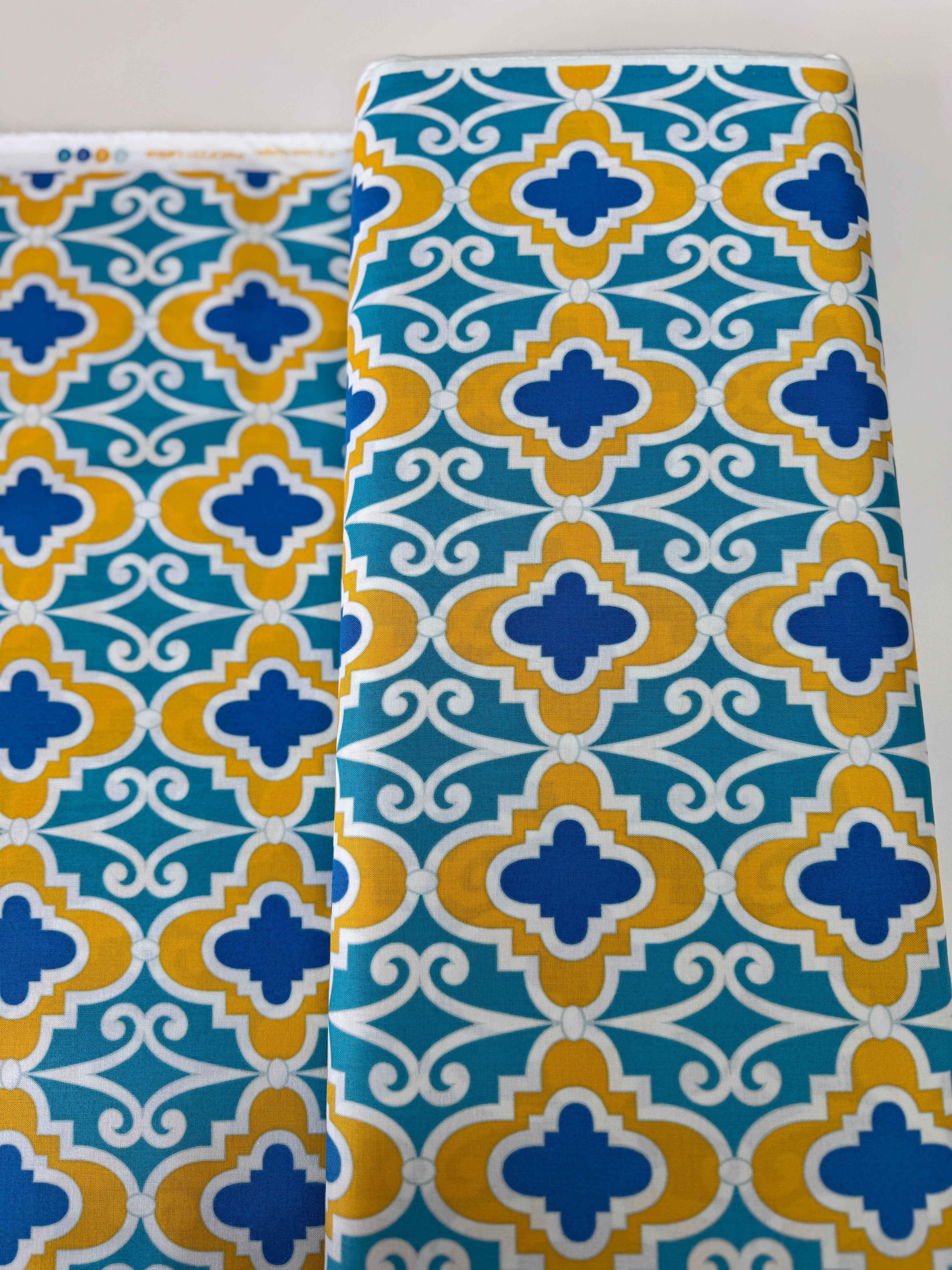 Turquoise lattice geometric cotton fabric with mustard and blue by Dena Designs.