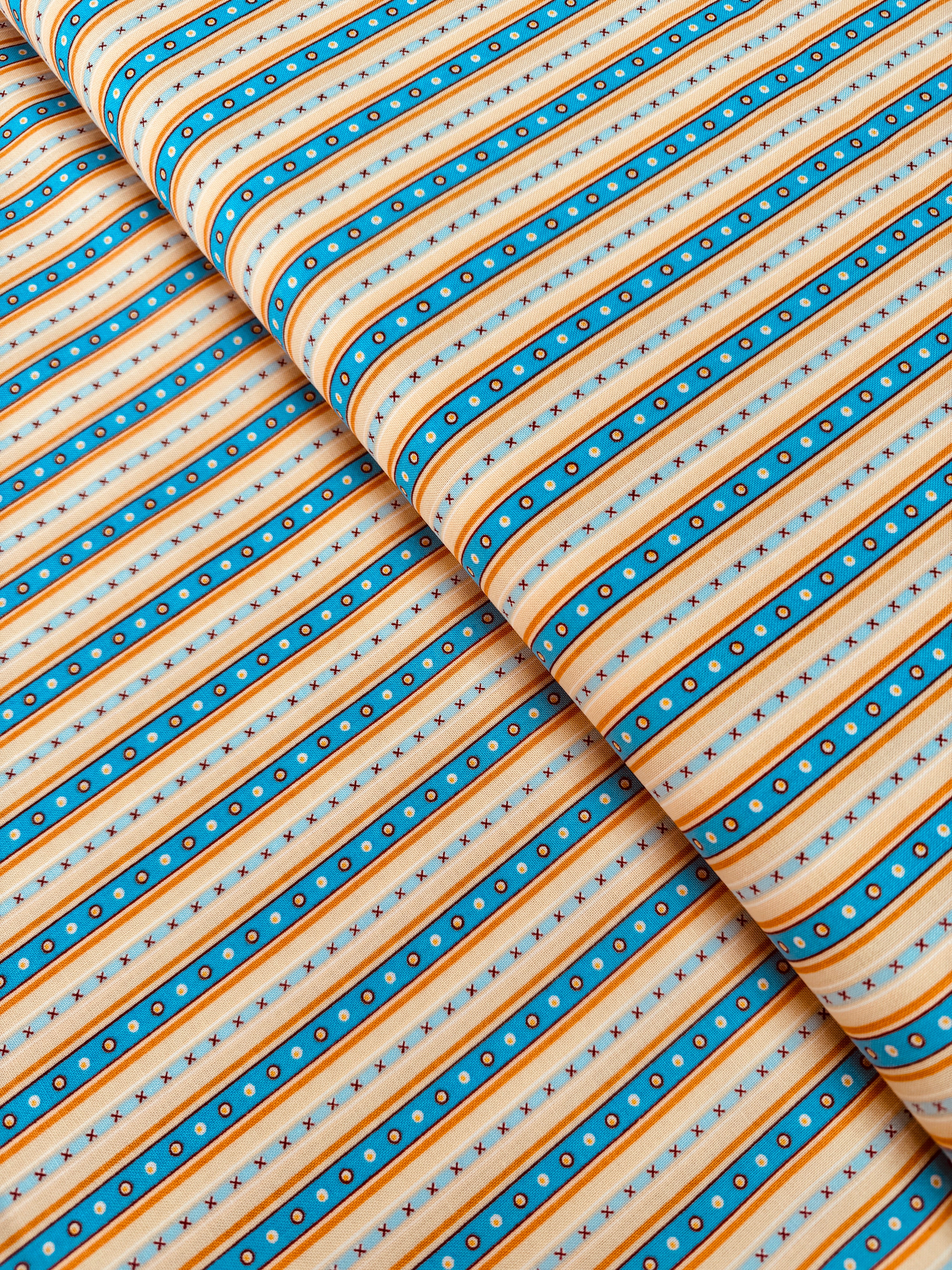 Chambray blue and tan narrow stripe cotton fabric by Patrick Lose for RJR Fabrics.