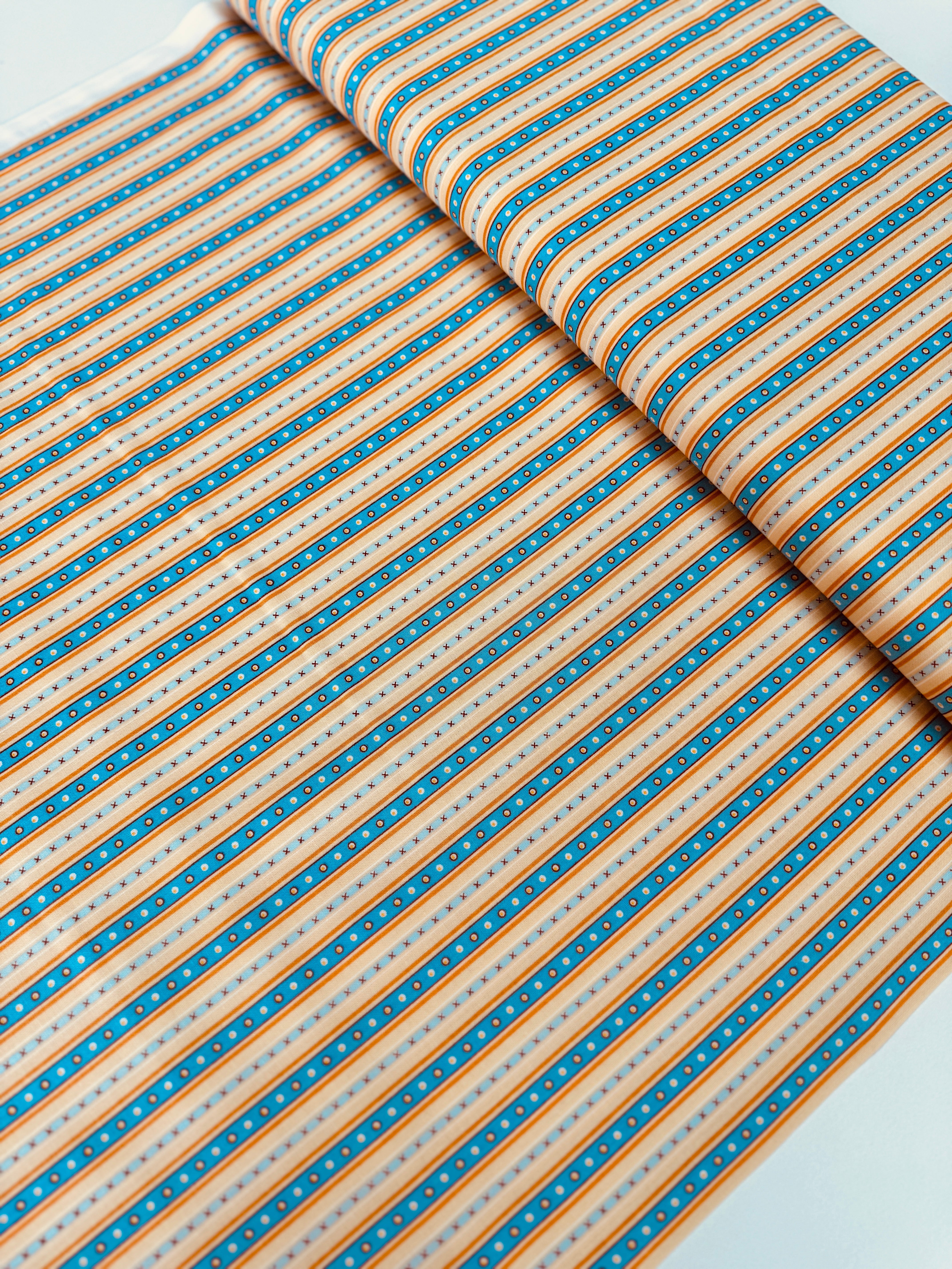Chambray blue and tan narrow stripe cotton fabric by Patrick Lose for RJR Fabrics.