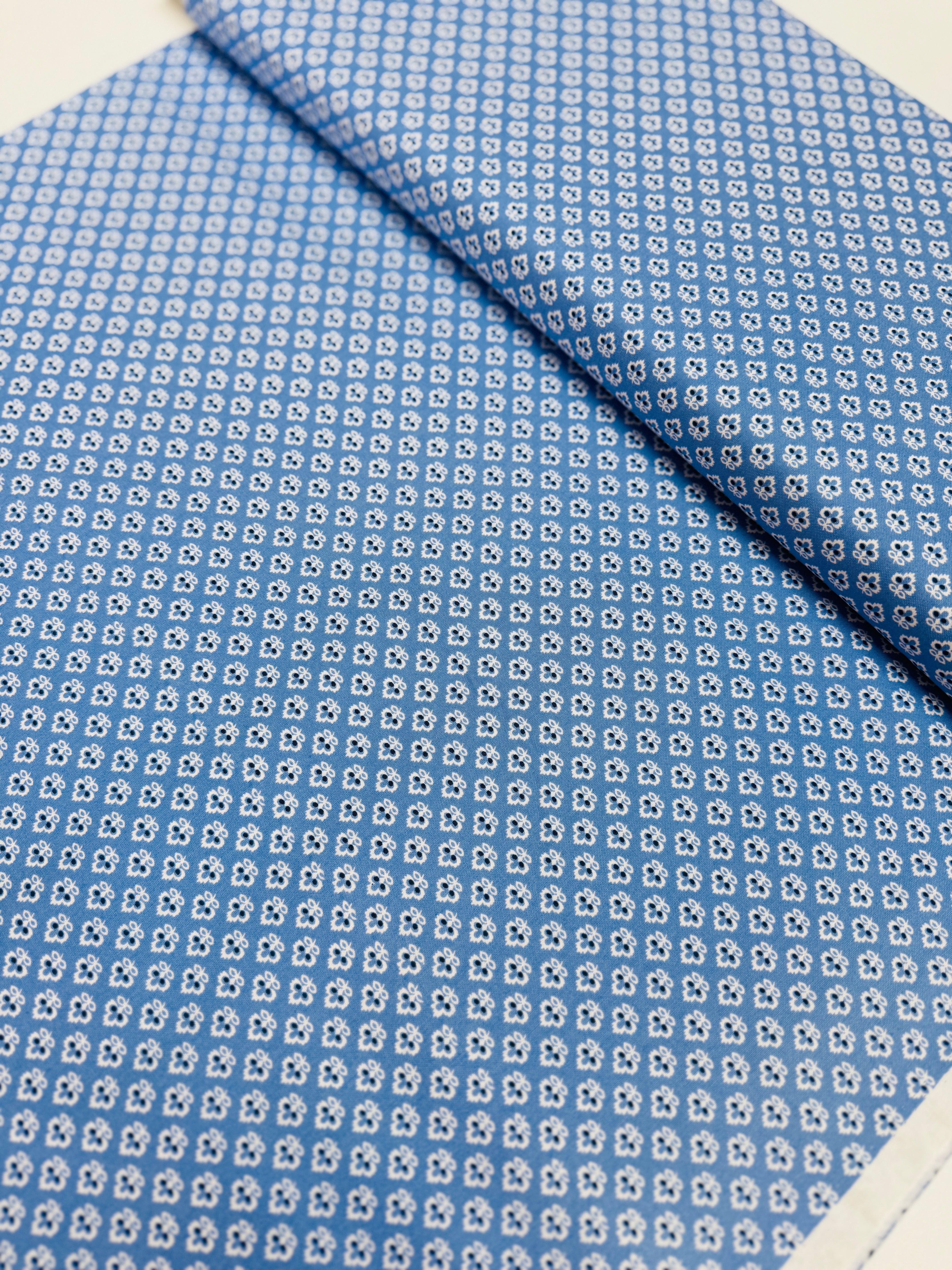 Blue cotton quilting fabric with tiny white floral ditsy print by Quilted Koala.