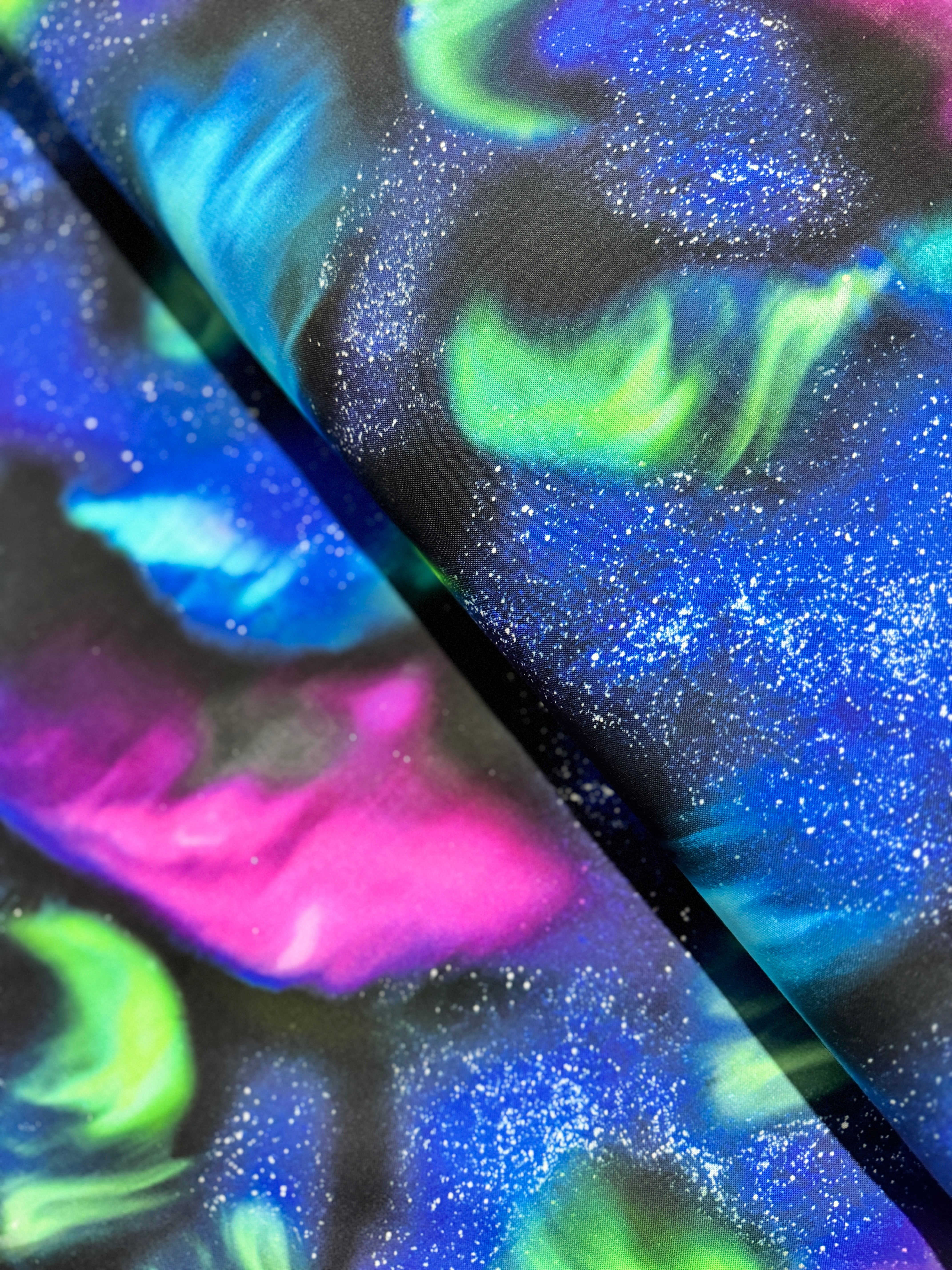 Aurora Sky Winter Light cotton fabric by Timeless Treasures featuring northern lights inspired print.