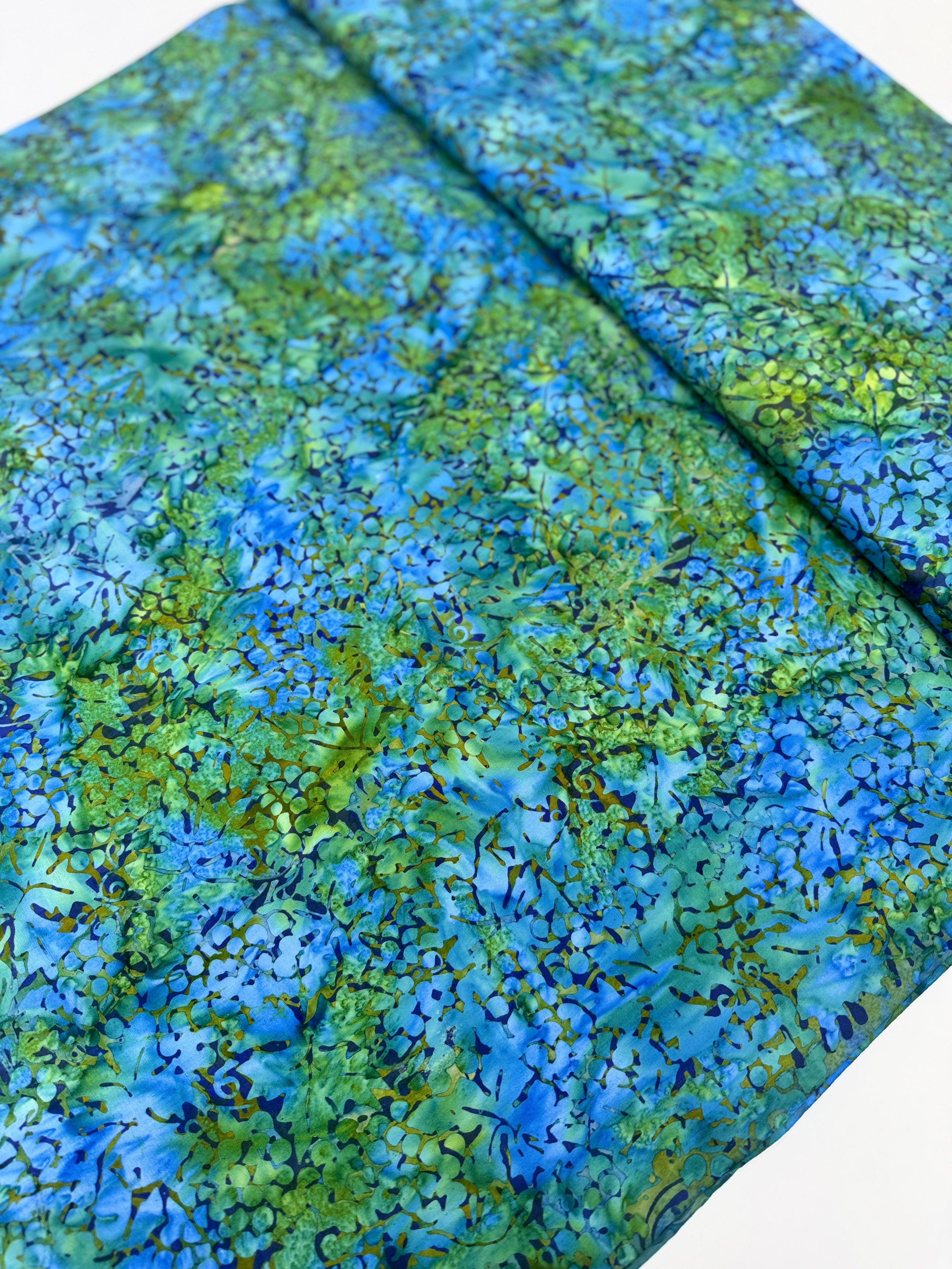 Blue and green Island Batik fabric with watercolor botanical pattern
