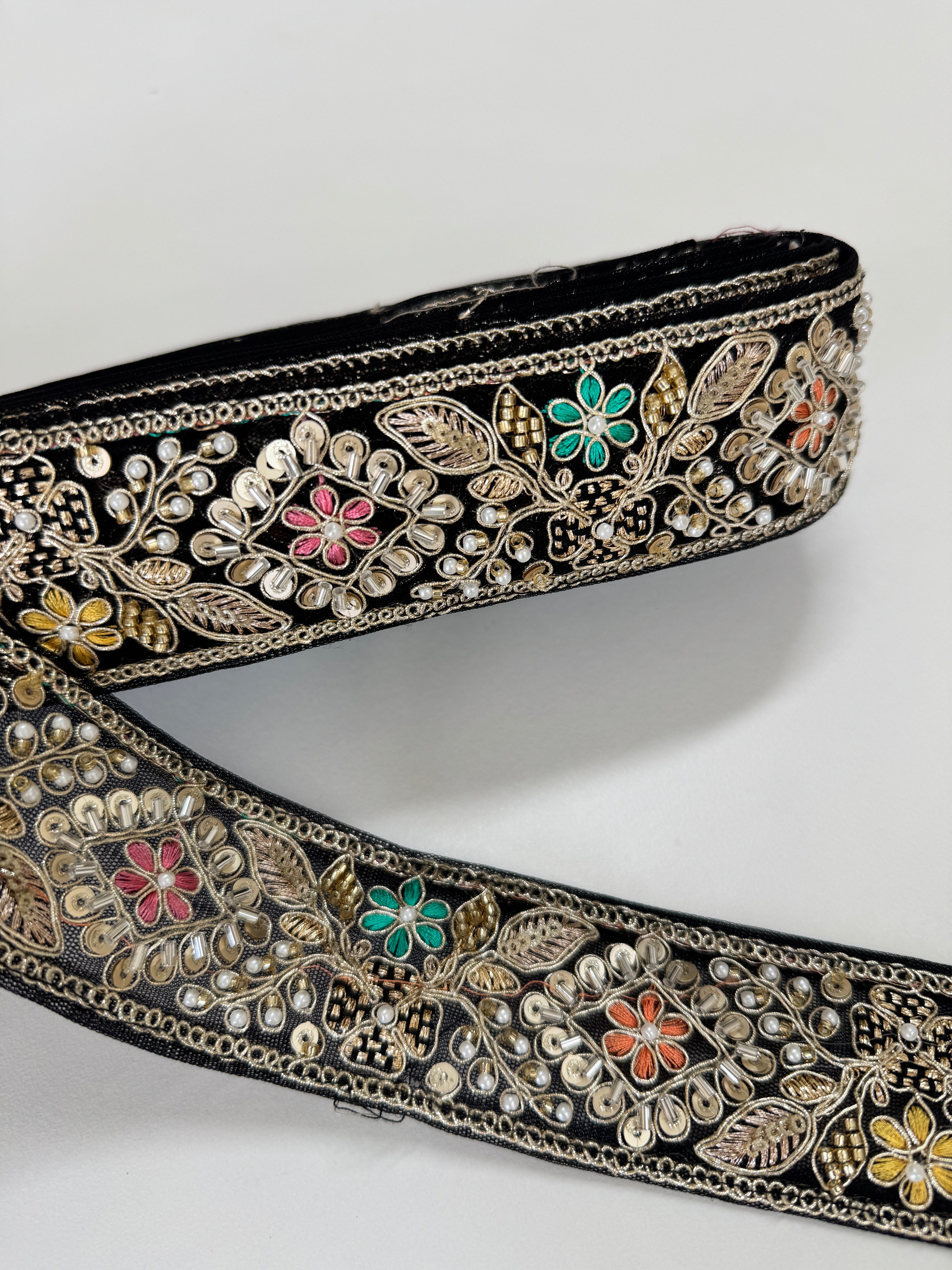 Black embroidered lace trim with gold thread and multicolor floral beadwork decorative border