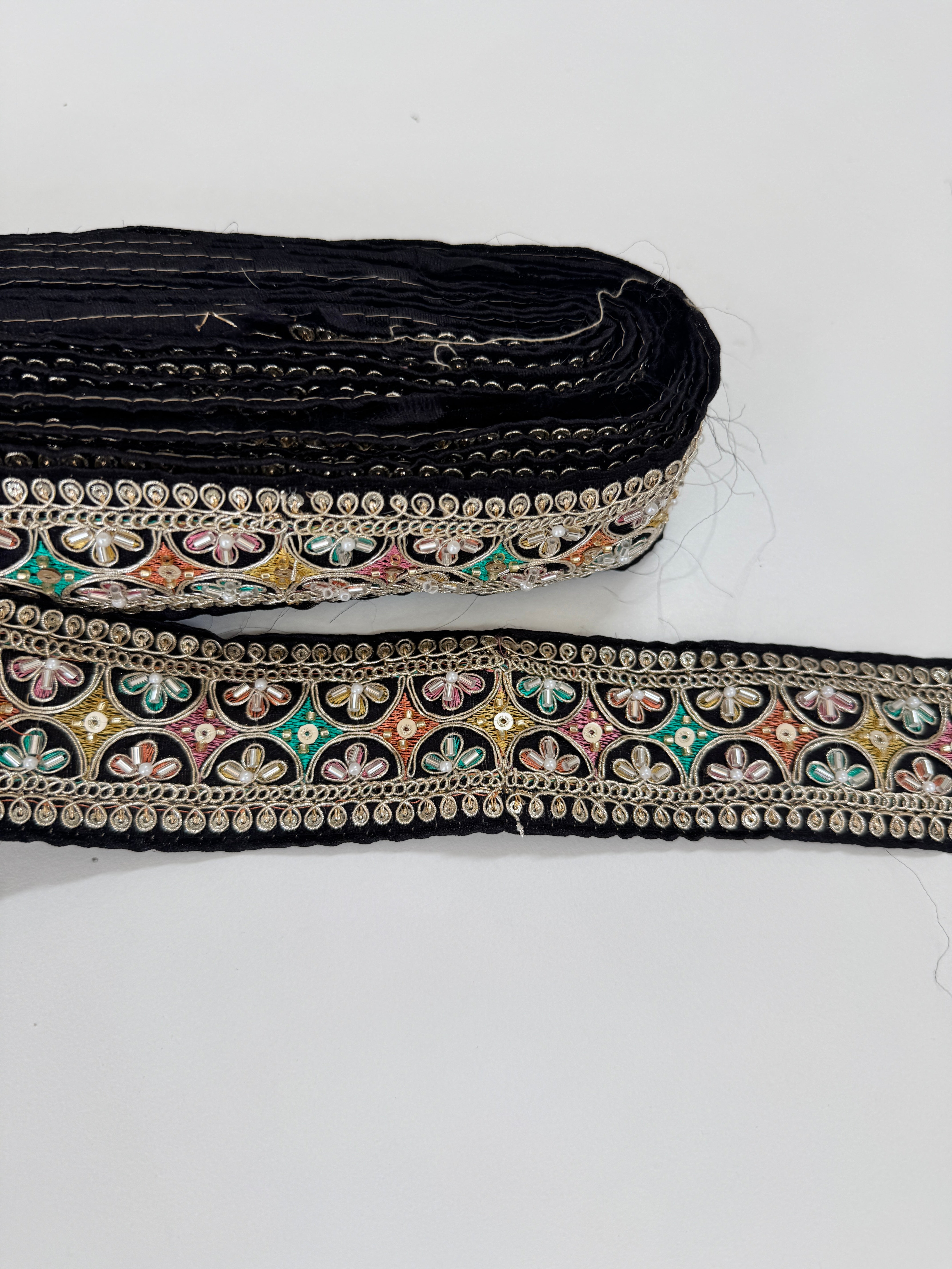 Multicolor embroidered trim on black with beads, sequins, and metallic thread detailing for lehengas, sarees, dupattas, costumes, accessories, and sewing projects.