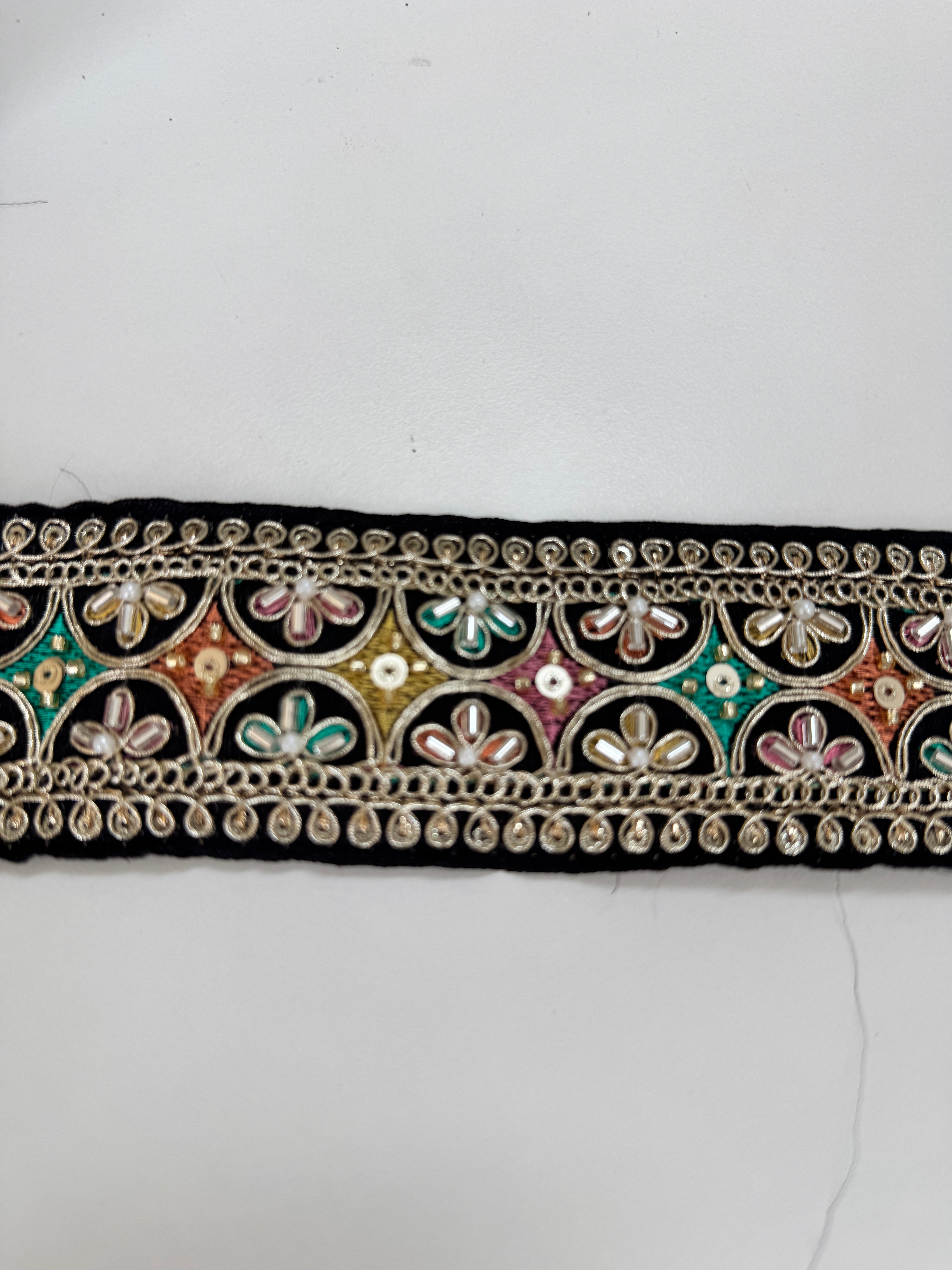 Multicolor embroidered trim on black with beads, sequins, and metallic thread detailing for lehengas, sarees, dupattas, costumes, accessories, and sewing projects.