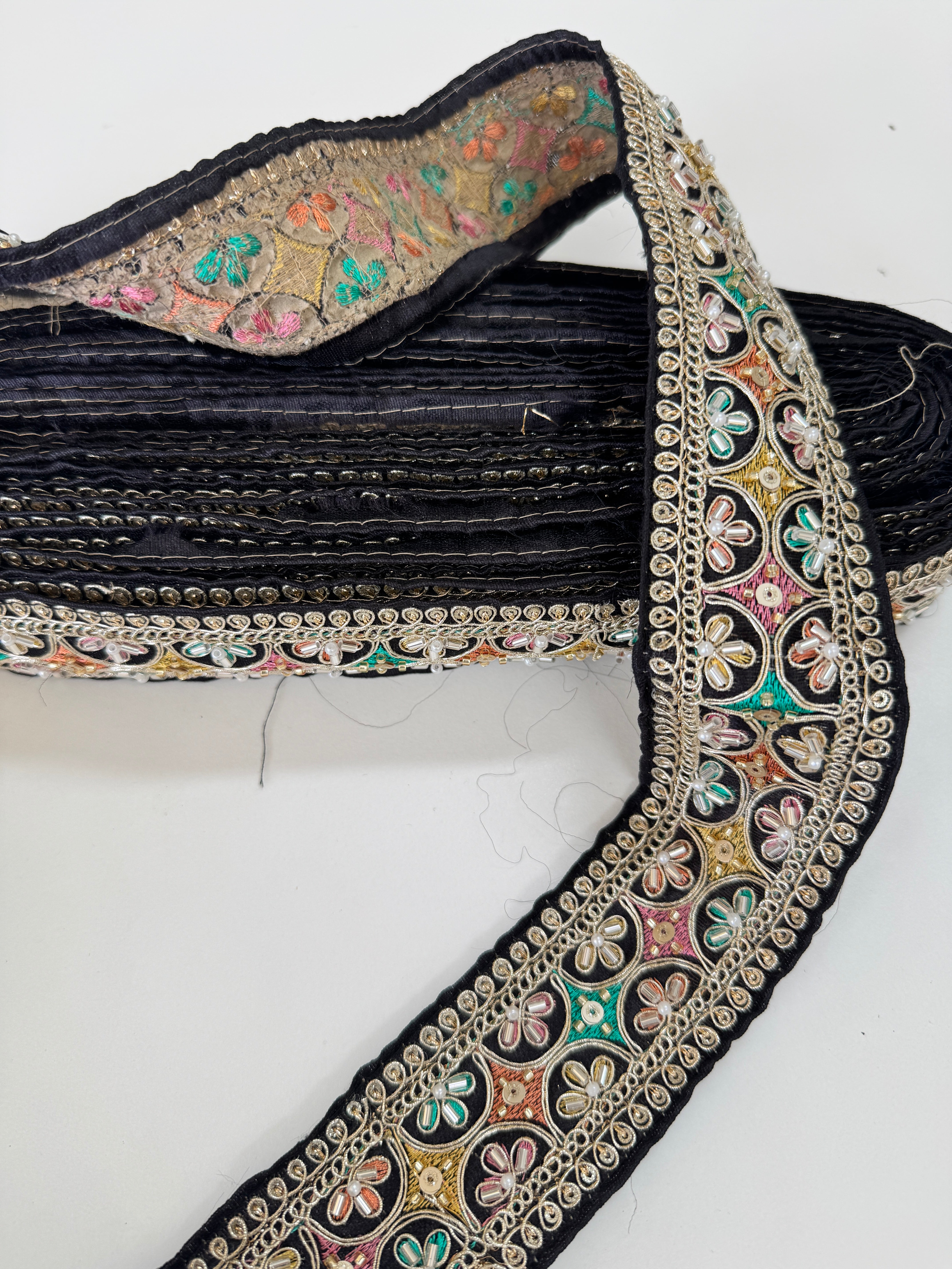 Multicolor embroidered trim on black with beads, sequins, and metallic thread detailing for lehengas, sarees, dupattas, costumes, accessories, and sewing projects.