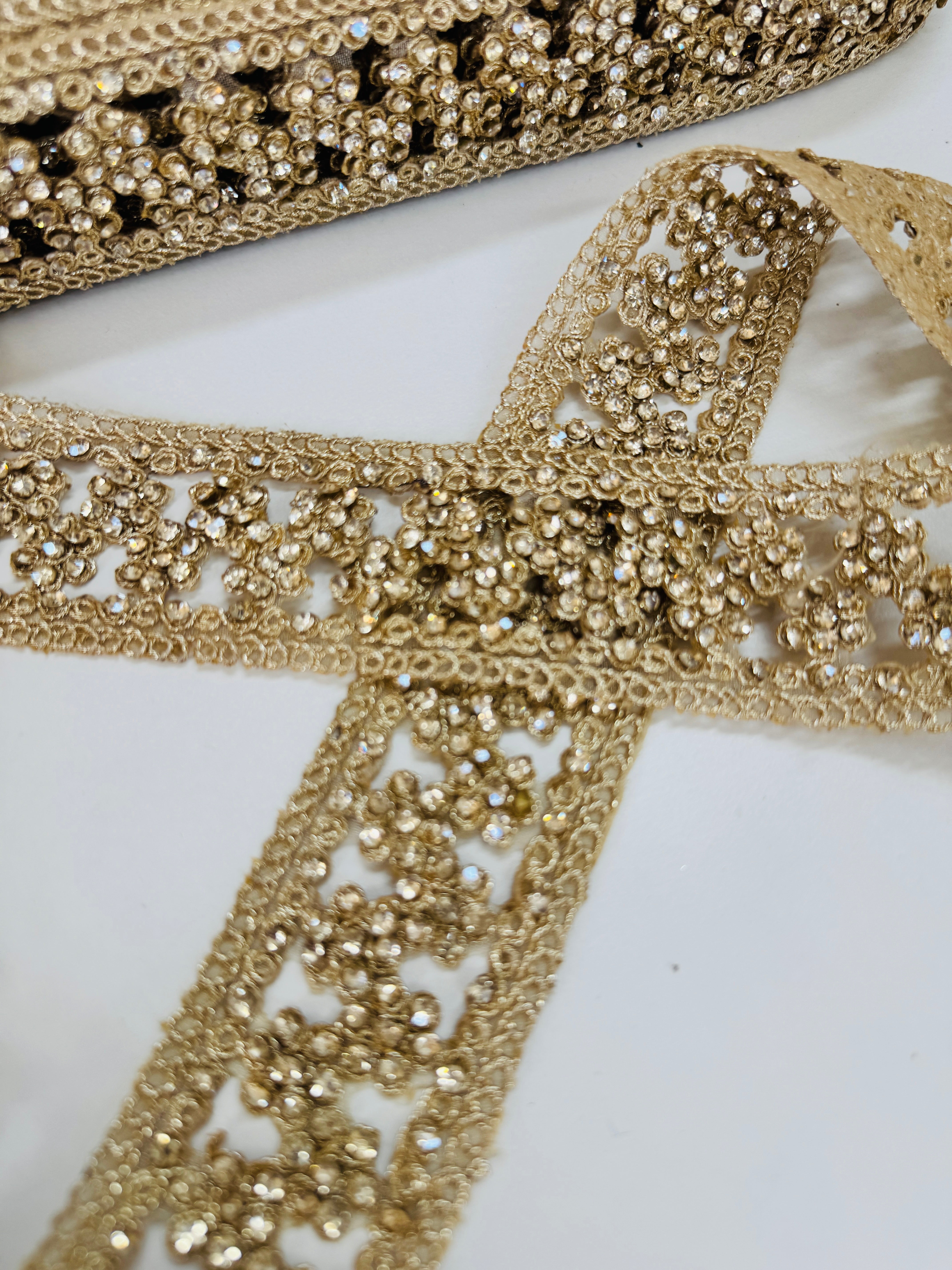 Champagne beaded lace trim with crystal embellishments and embroidered openwork design for bridal gowns, veils, lehengas, sarees, and couture sewing projects.