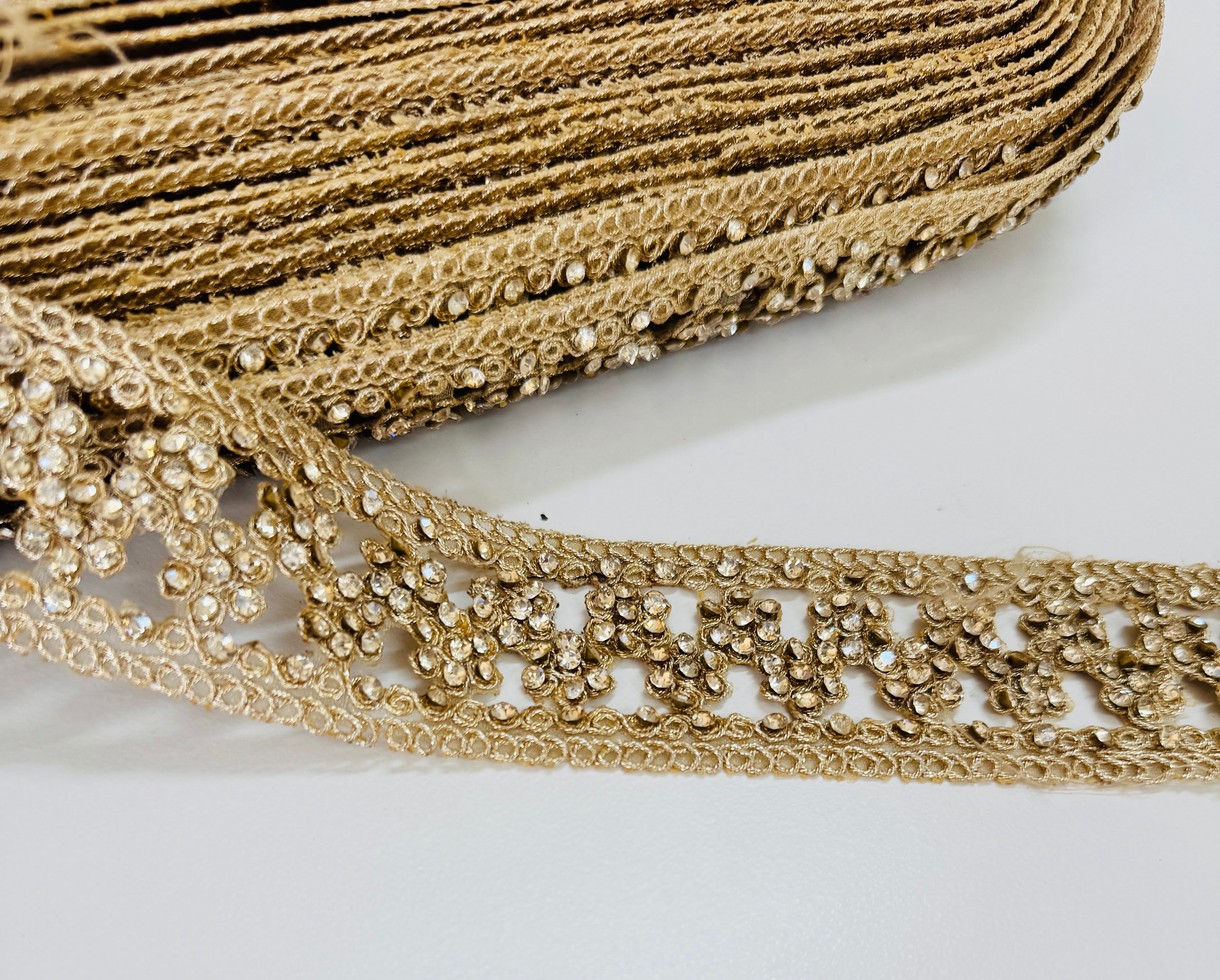 Champagne beaded lace trim with crystal embellishments and embroidered openwork design for bridal gowns, veils, lehengas, sarees, and couture sewing projects.