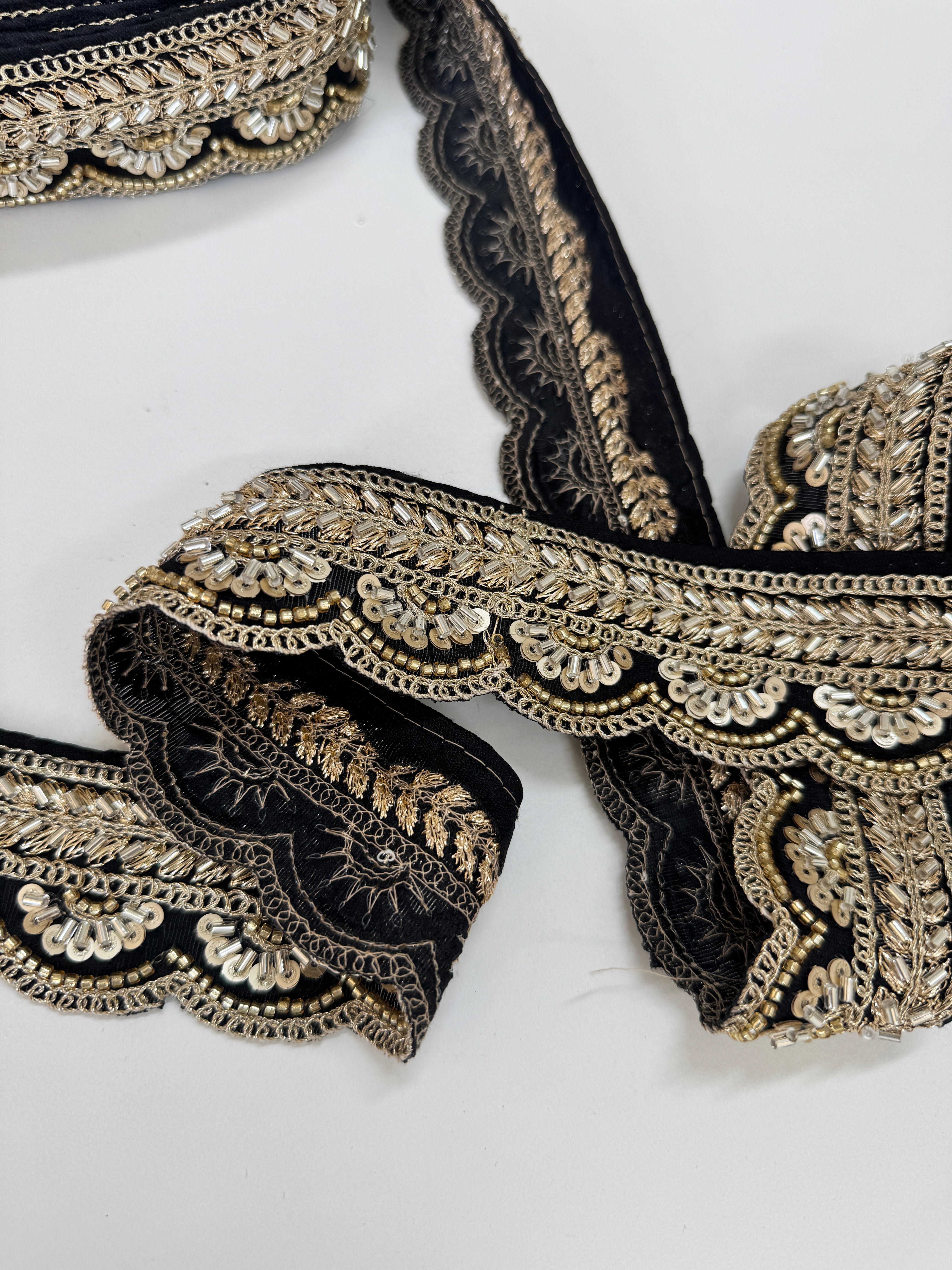 Black and gold beaded scalloped trim with sequins and bugle beads for sarees, lehengas, gowns, veils, and couture sewing projects.