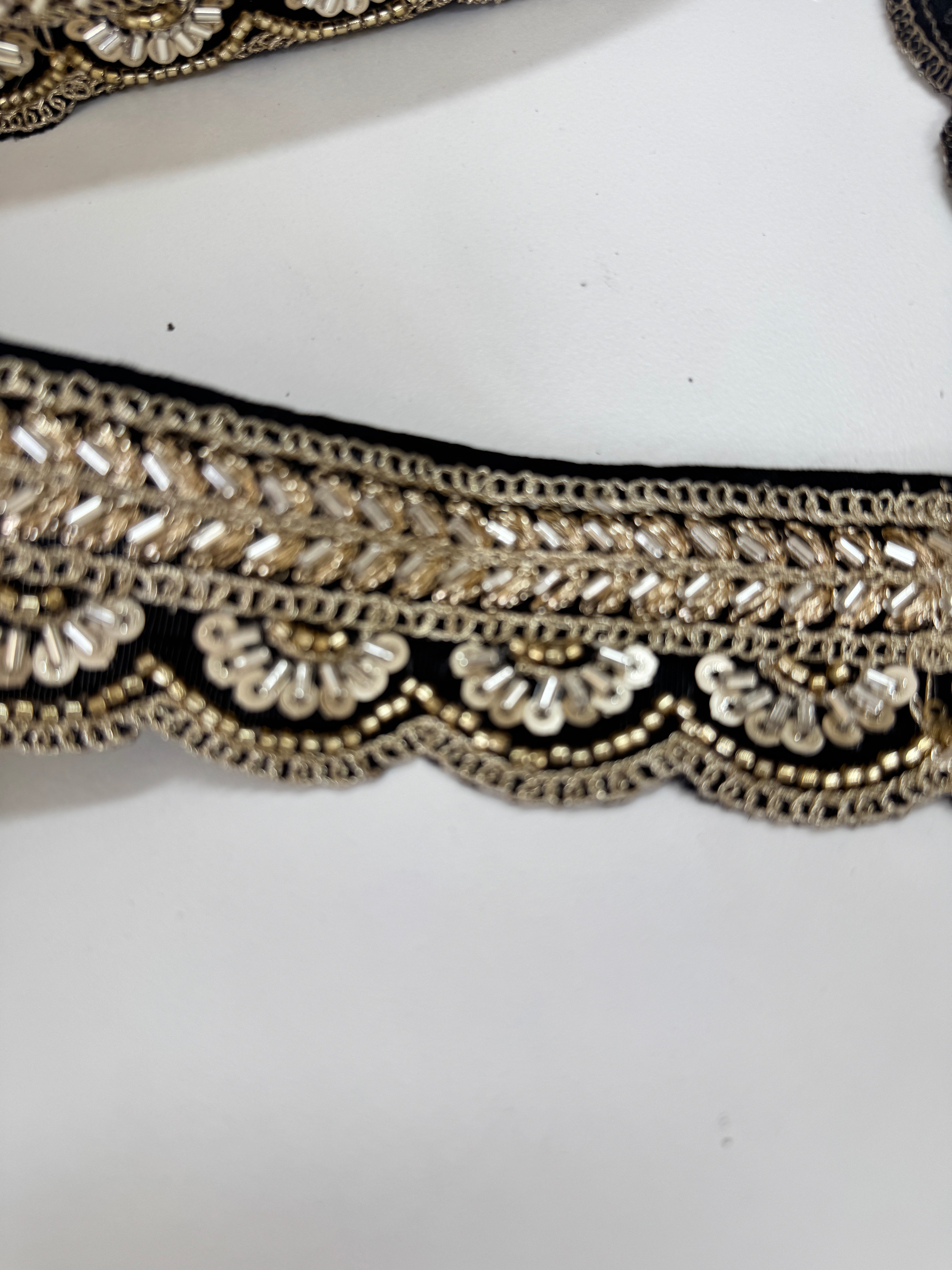 Black and gold beaded scalloped trim with sequins and bugle beads for sarees, lehengas, gowns, veils, and couture sewing projects.