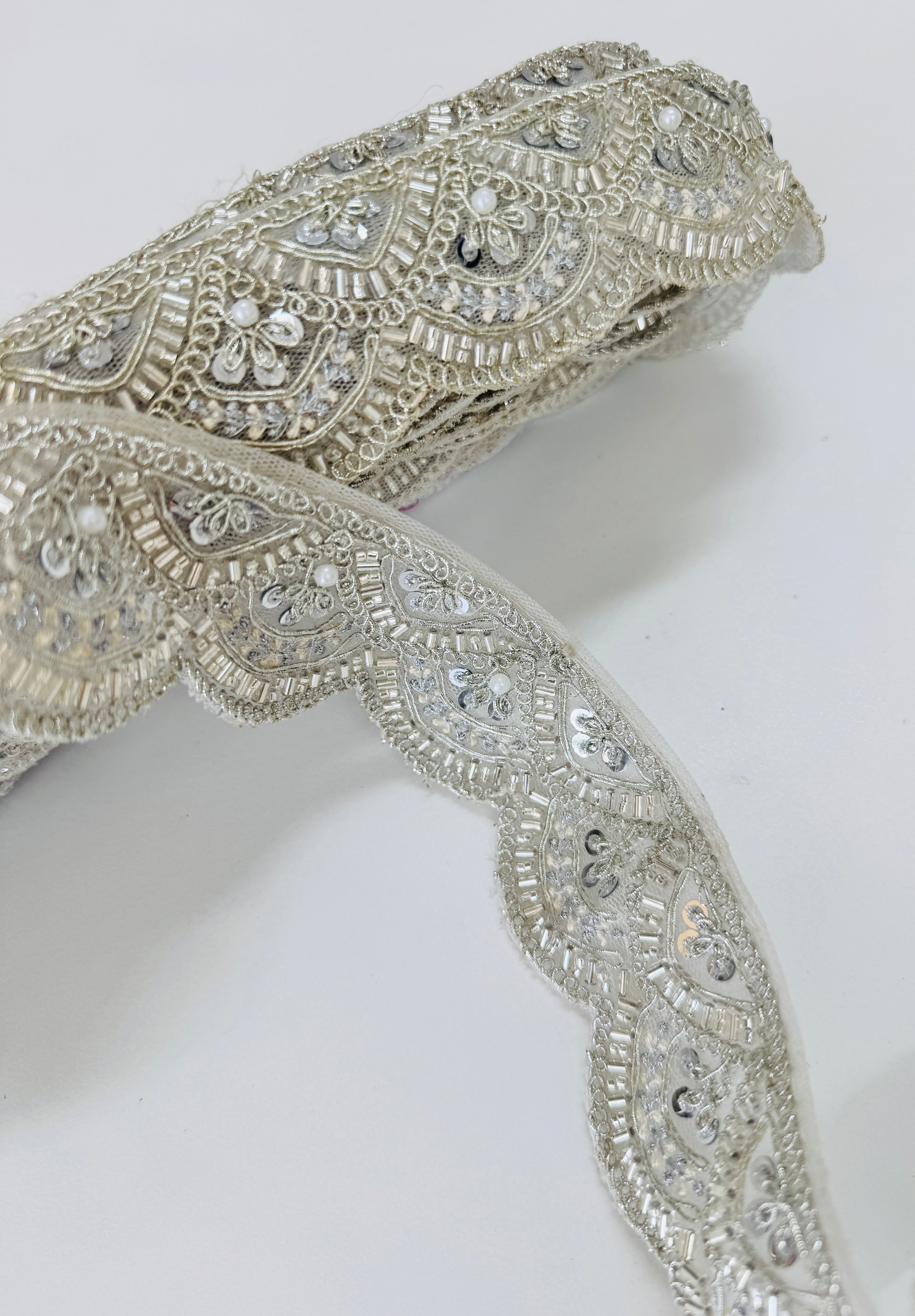 Ivory pearl beaded scalloped lace trim with intricate embroidery, sequins, and pearl embellishments for bridal gowns, veils, sarees, lehengas, christening dresses, and couture sewing projects.