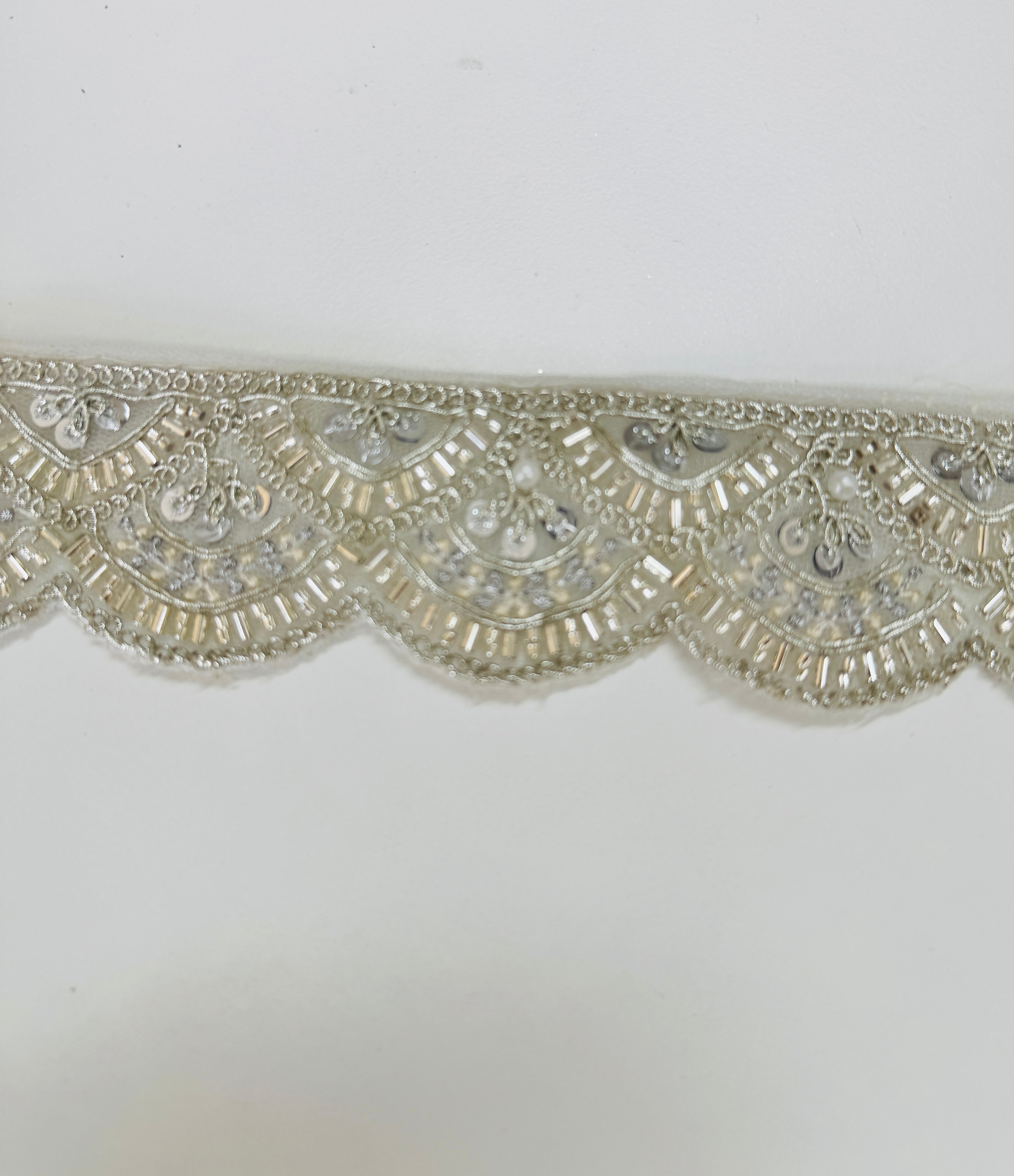 Ivory pearl beaded scalloped lace trim with intricate embroidery, sequins, and pearl embellishments for bridal gowns, veils, sarees, lehengas, christening dresses, and couture sewing projects.