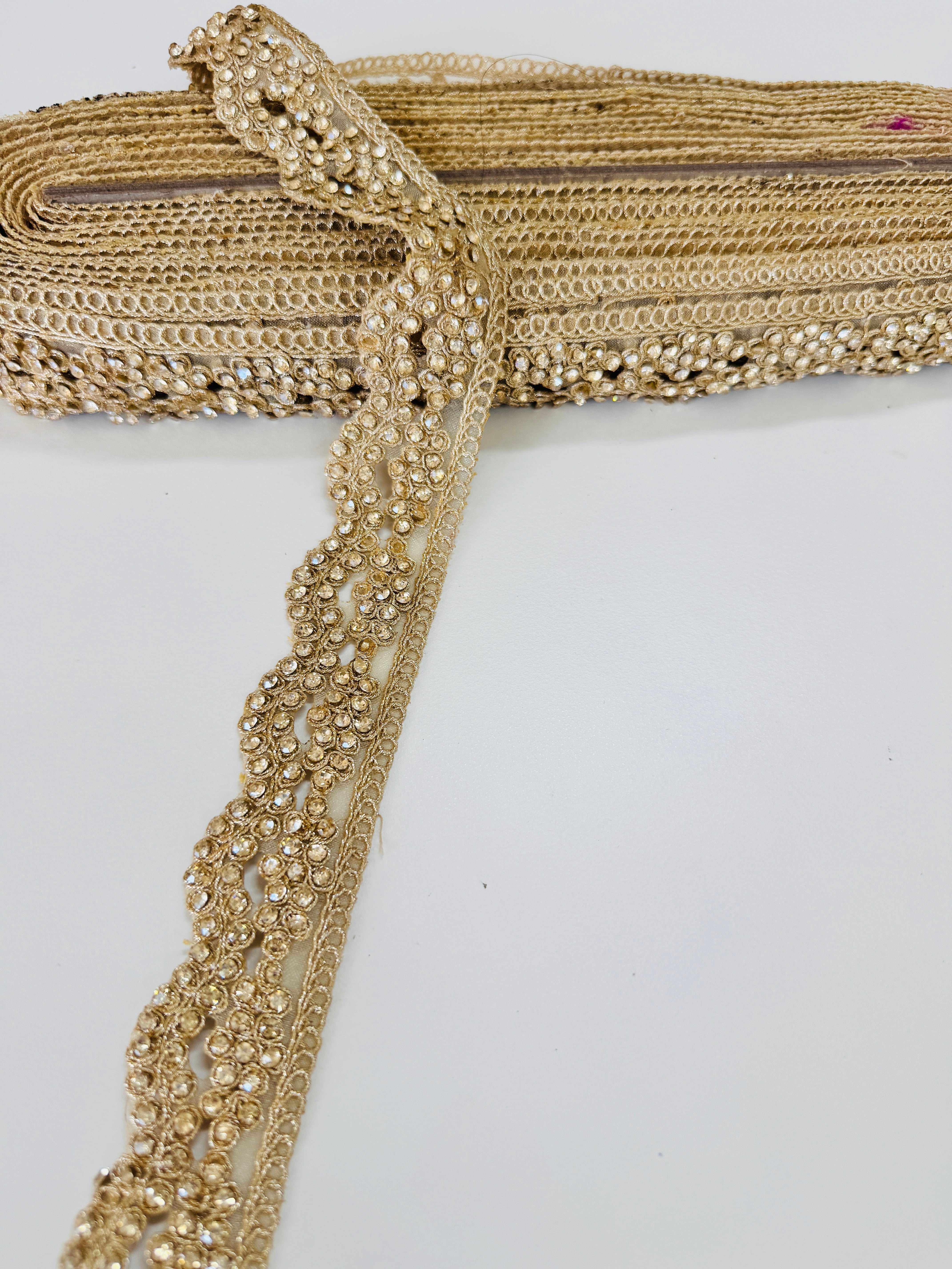 Champagne gold crystal beaded lace trim with intricate embroidery and sparkling embellishments for bridal gowns, sarees, lehengas, veils, and couture sewing projects.