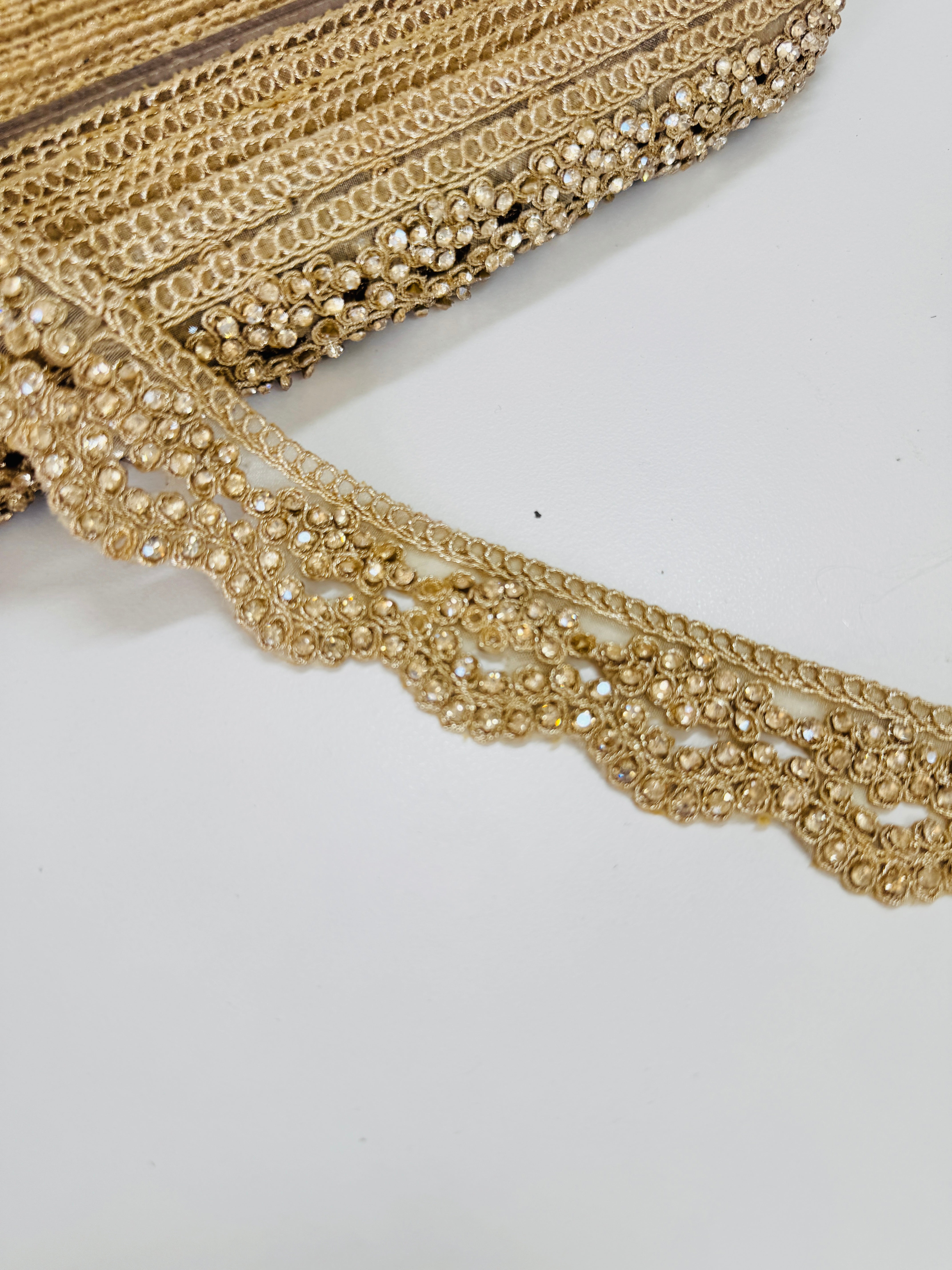 Champagne gold crystal beaded lace trim with intricate embroidery and sparkling embellishments for bridal gowns, sarees, lehengas, veils, and couture sewing projects.