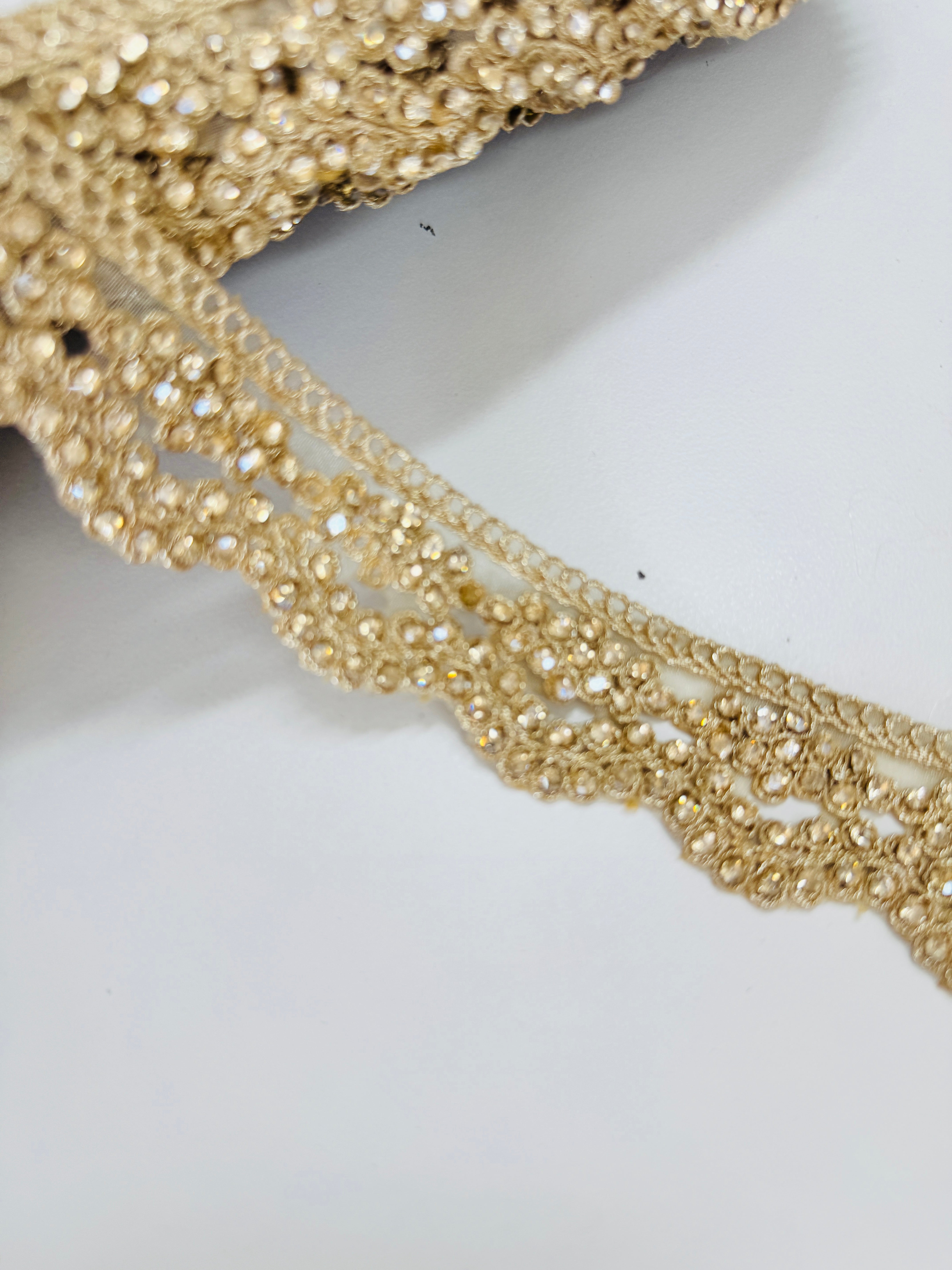 Champagne gold crystal beaded lace trim with intricate embroidery and sparkling embellishments for bridal gowns, sarees, lehengas, veils, and couture sewing projects.