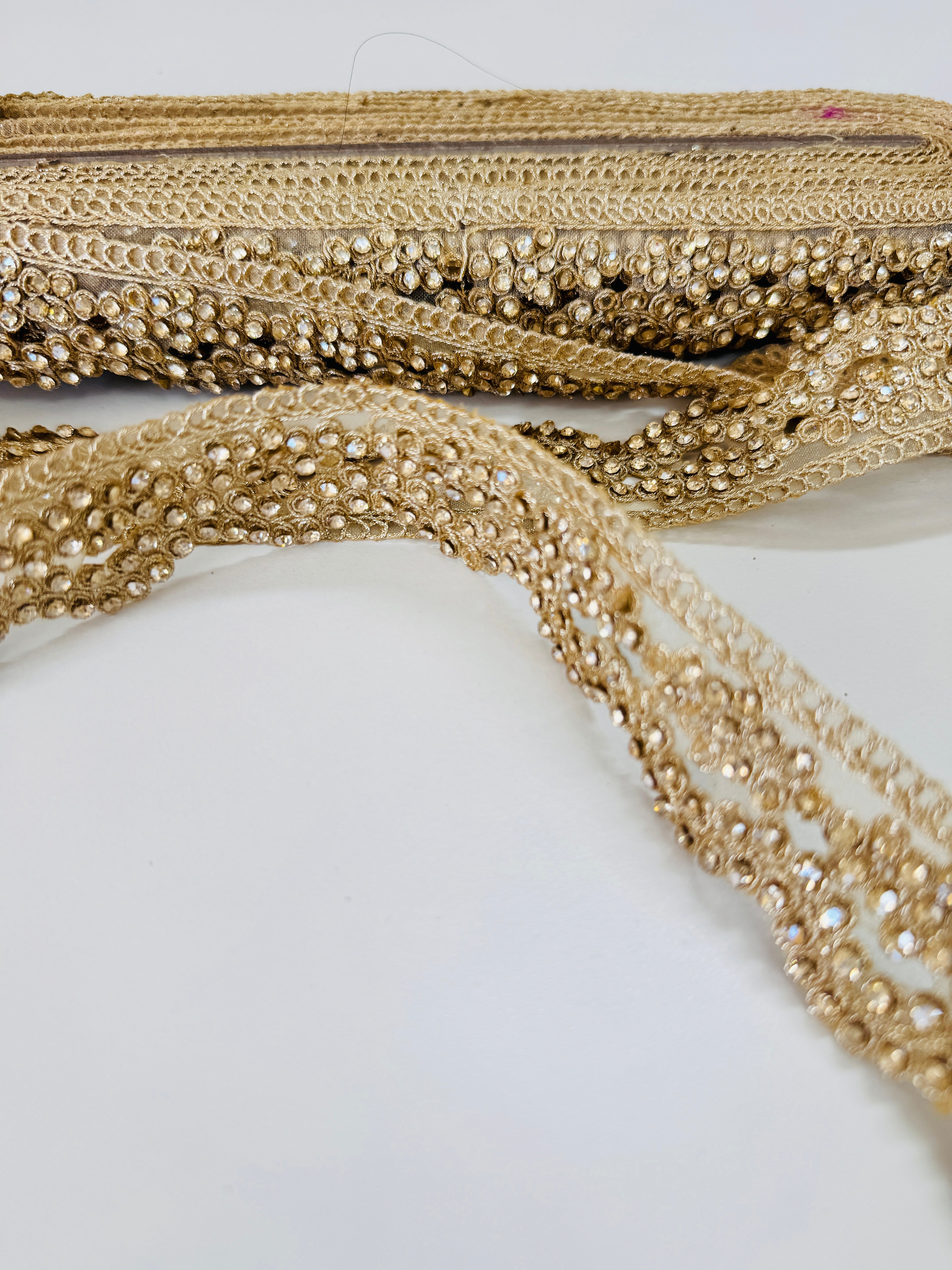Champagne gold crystal beaded lace trim with intricate embroidery and sparkling embellishments for bridal gowns, sarees, lehengas, veils, and couture sewing projects.