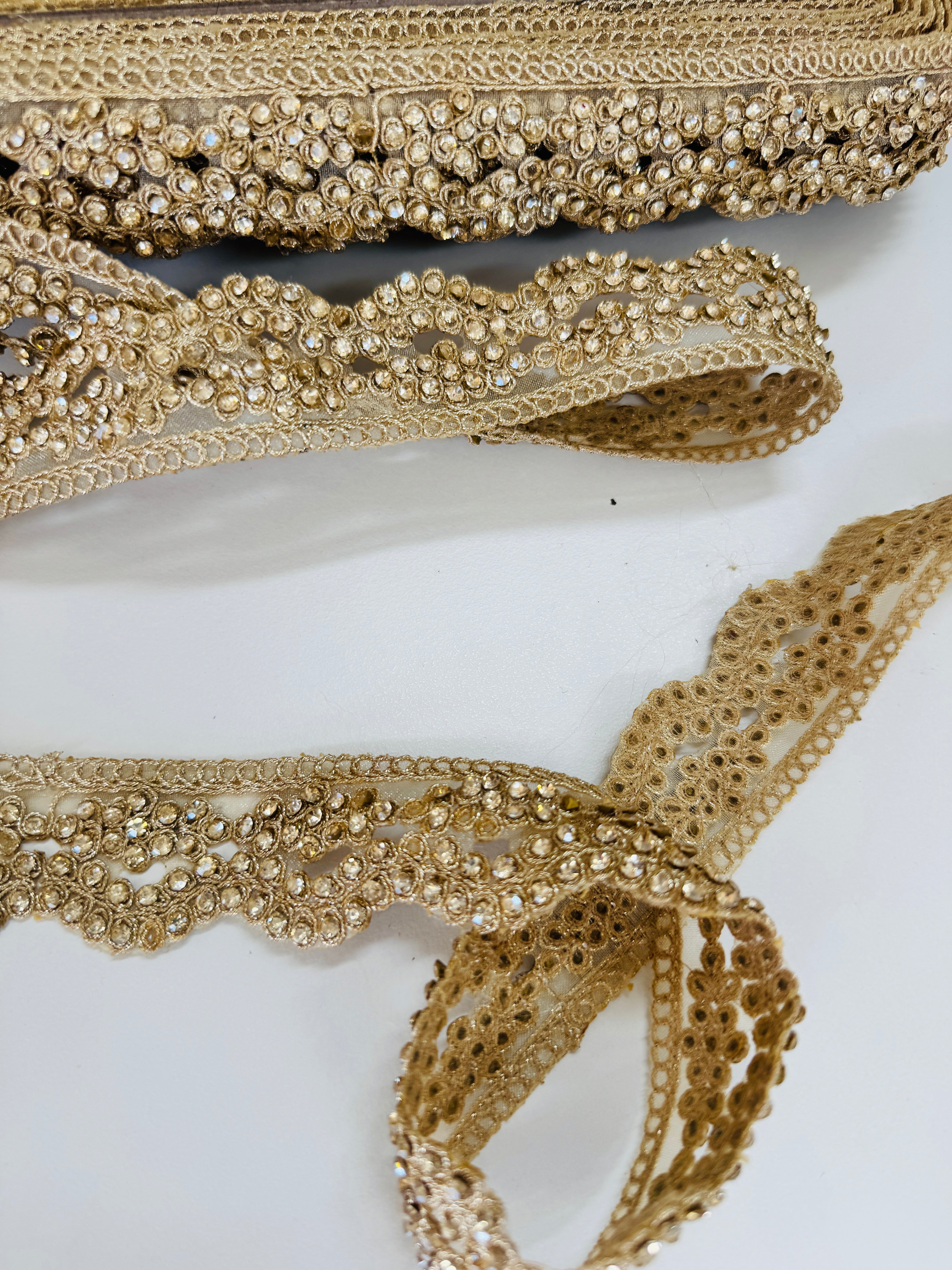 Champagne gold crystal beaded lace trim with intricate embroidery and sparkling embellishments for bridal gowns, sarees, lehengas, veils, and couture sewing projects.