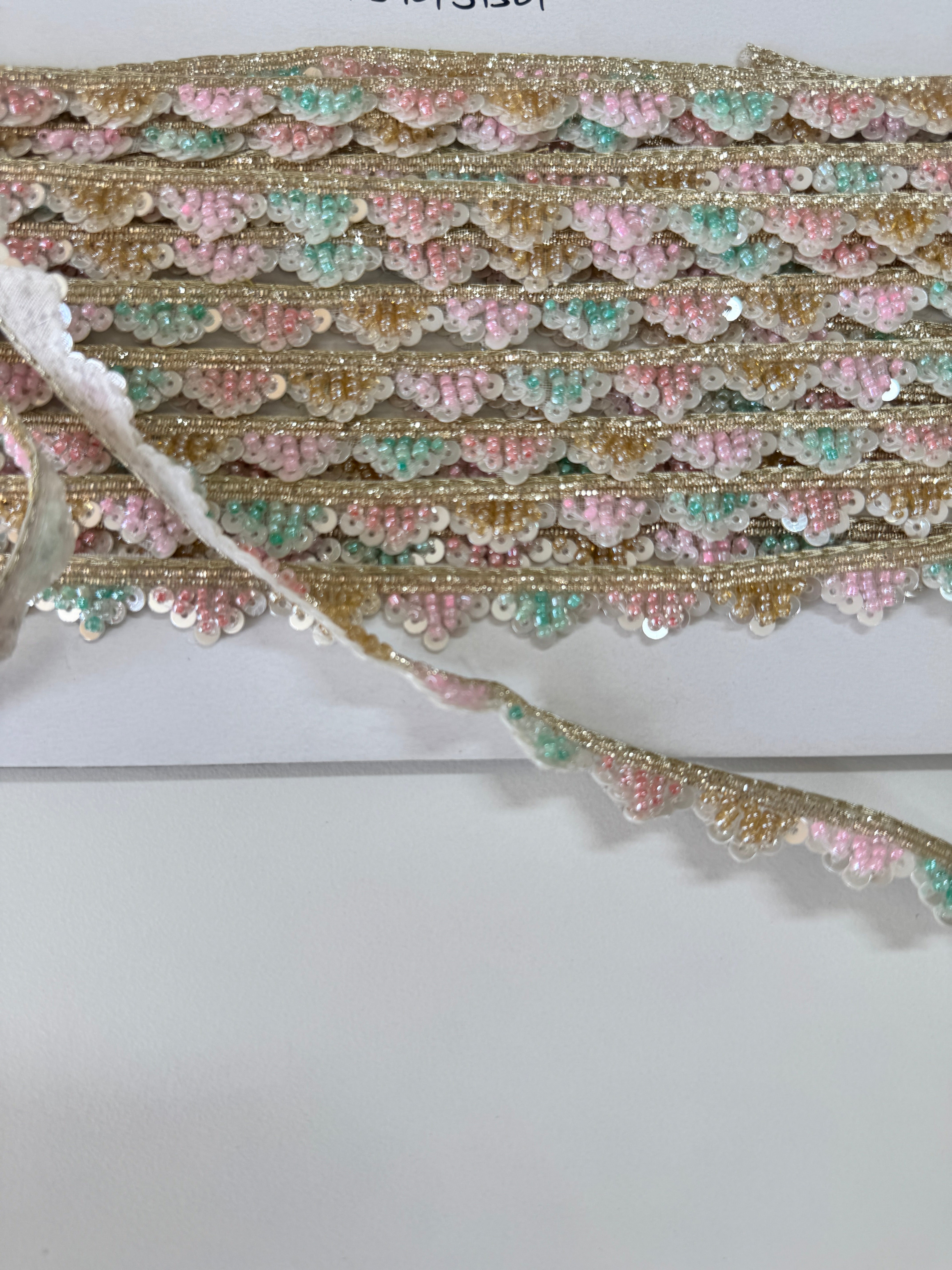 Pastel pink, mint, ivory, and gold beaded sequin trim with metallic edging.