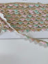 Pastel pink, mint, ivory, and gold beaded sequin trim with metallic edging.
