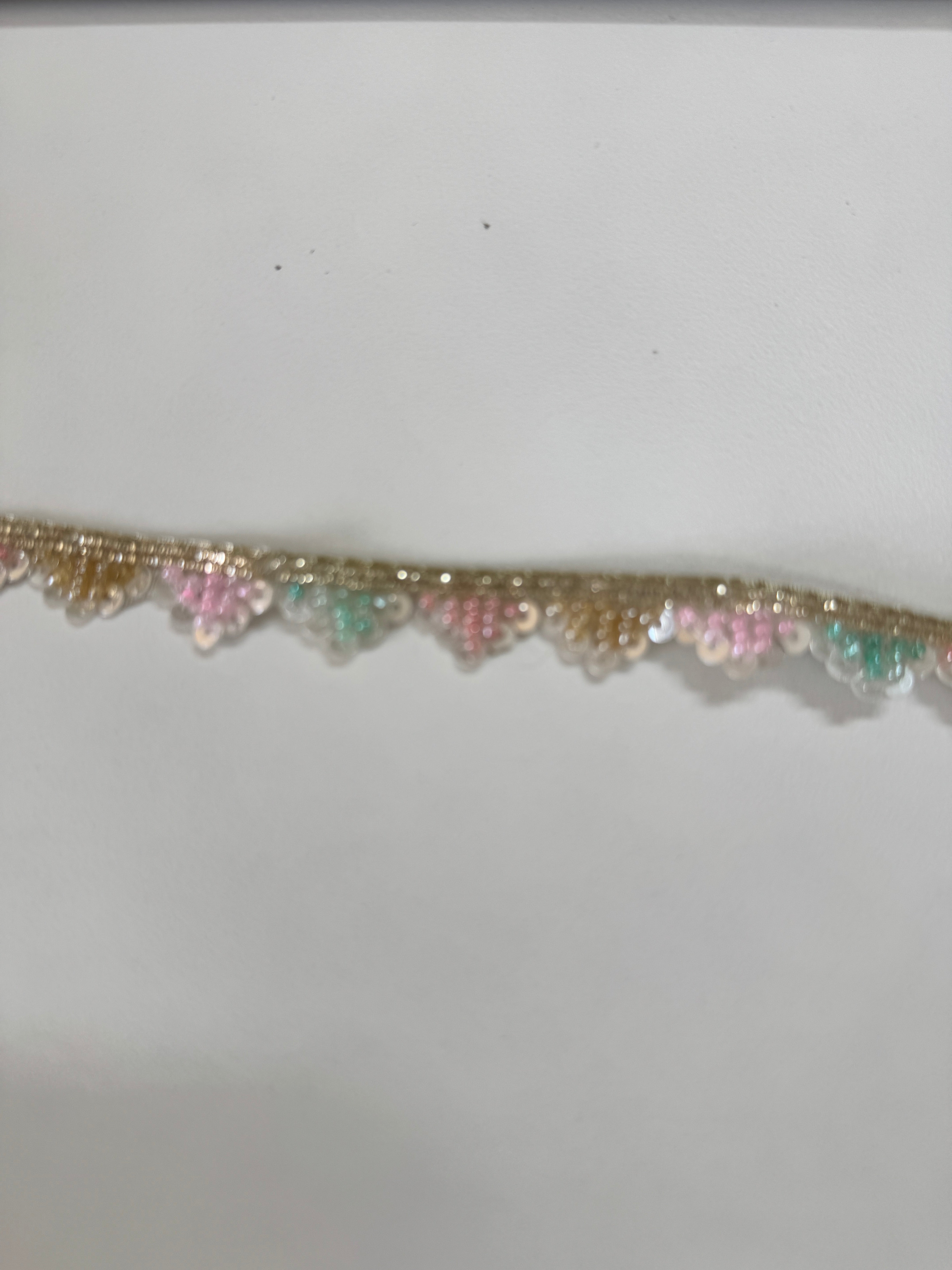 Pastel pink, mint, ivory, and gold beaded sequin trim with metallic edging.