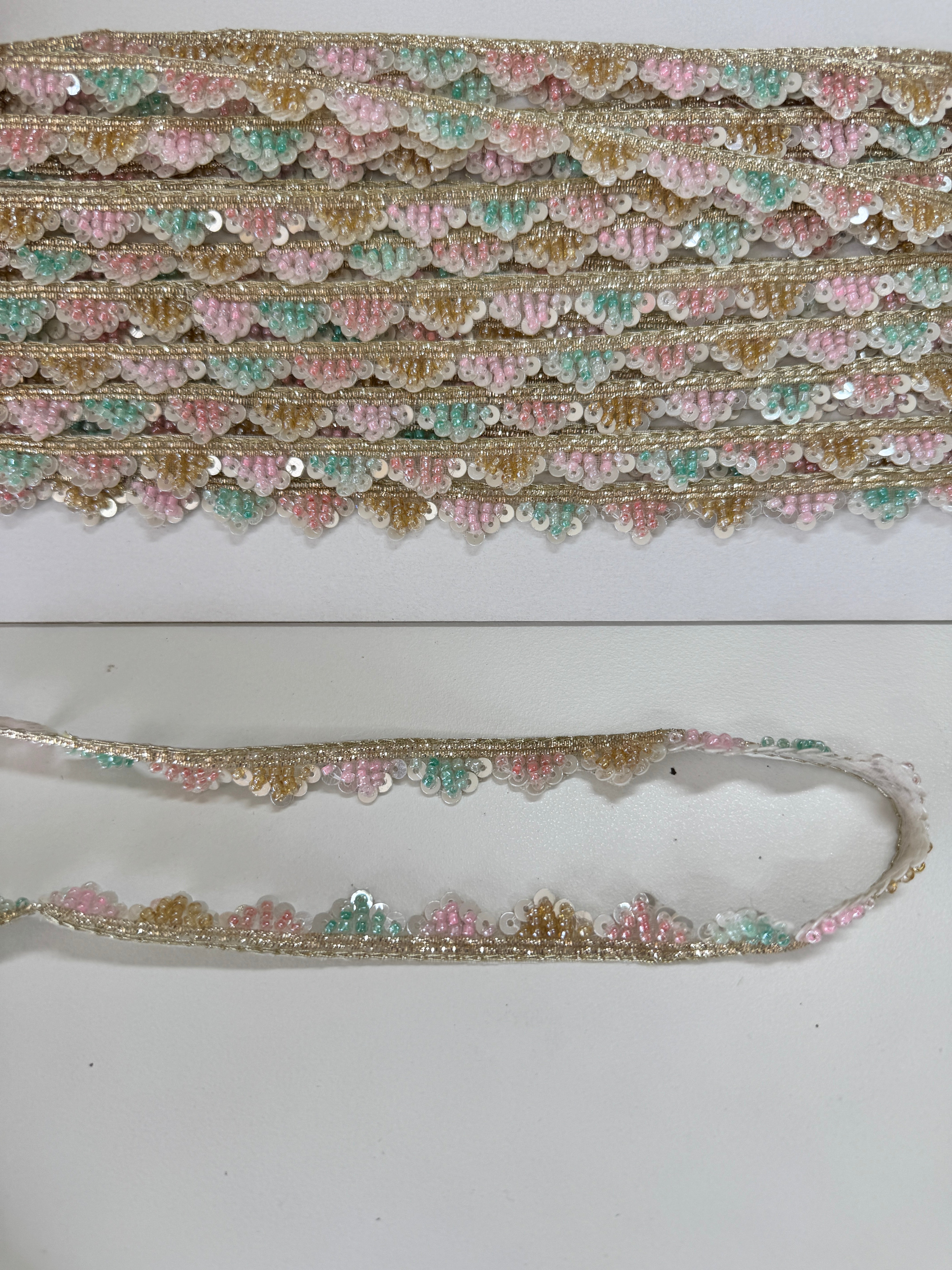 Pastel pink, mint, ivory, and gold beaded sequin trim with metallic edging.