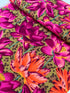 Large pink, magenta, and coral lotus flowers on an ochre leopard-print background, Leopard Lotus Ochre fabric by Philip Jacobs for FreeSpirit Fabrics.