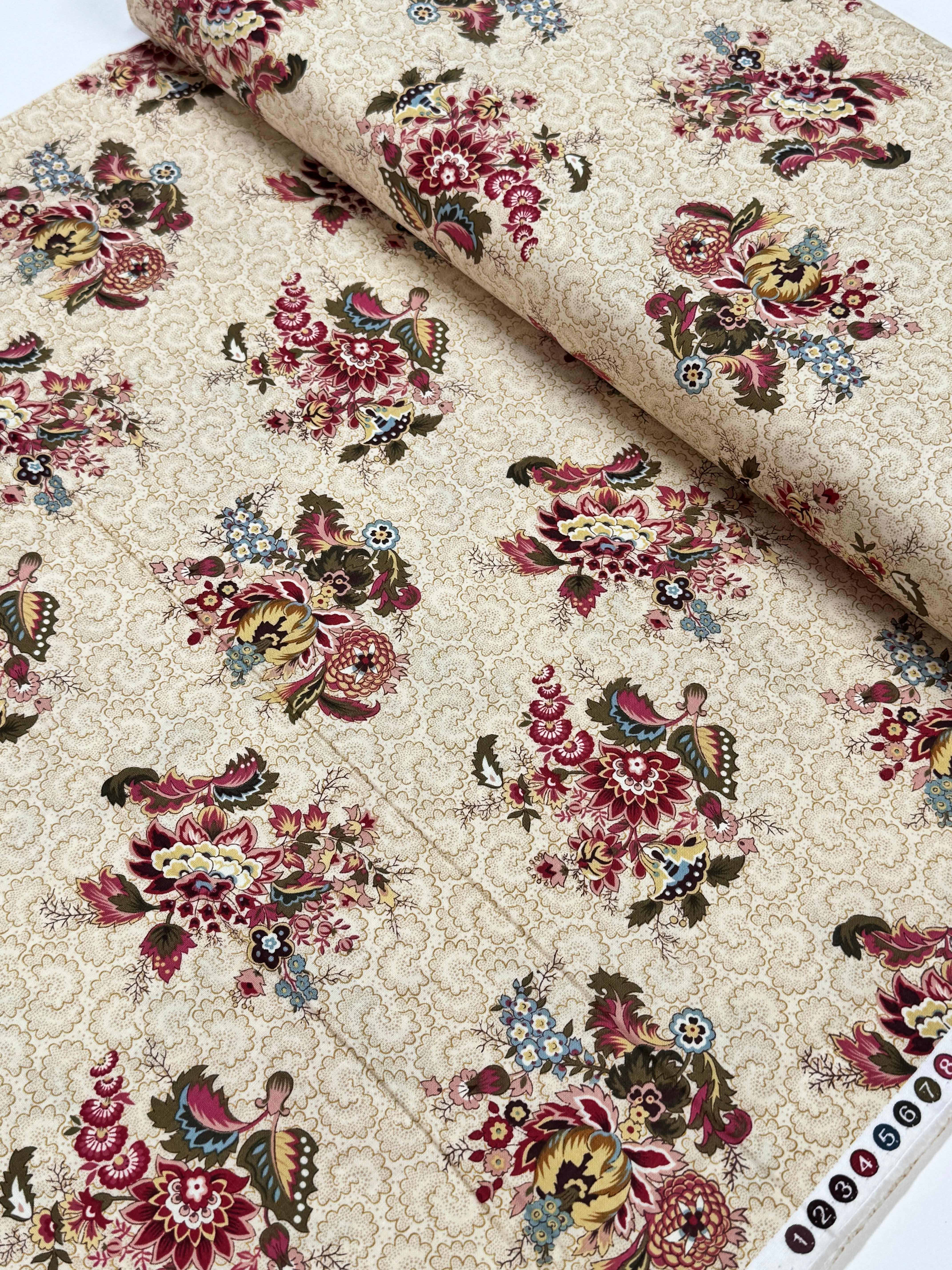 Vintage floral cotton fabric featuring colorful bouquet medallions on a cream foulard background, Marseille collection by Dover Hill for Benartex.