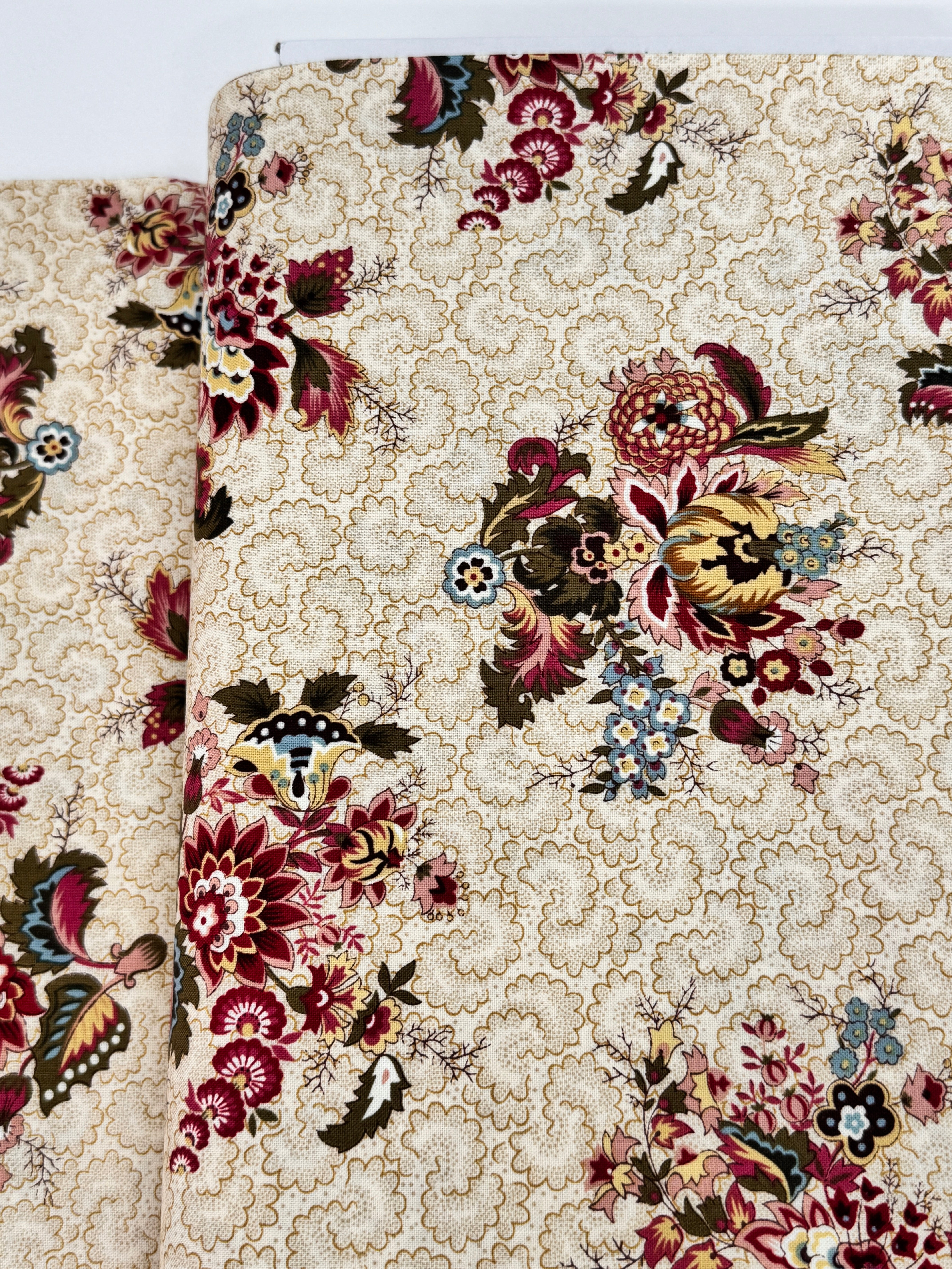 Vintage floral cotton fabric featuring colorful bouquet medallions on a cream foulard background, Marseille collection by Dover Hill for Benartex.