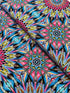 Where in the World Rio Blue Multi cotton fabric by Paula Nadelstern featuring colorful kaleidoscope medallions in blue pink yellow and black.