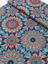 Where in the World Rio Blue Multi cotton fabric by Paula Nadelstern featuring colorful kaleidoscope medallions in blue pink yellow and black.