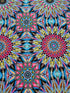 Where in the World Rio Blue Multi cotton fabric by Paula Nadelstern featuring colorful kaleidoscope medallions in blue pink yellow and black.