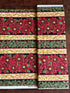 Holiday Flourish 12 poinsettia stripe black metallic fabric featuring red poinsettias, holly leaves, and gold scrollwork by Peggy Toole for Robert Kaufman.