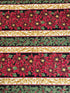 Holiday Flourish 12 poinsettia stripe black metallic fabric featuring red poinsettias, holly leaves, and gold scrollwork by Peggy Toole for Robert Kaufman.