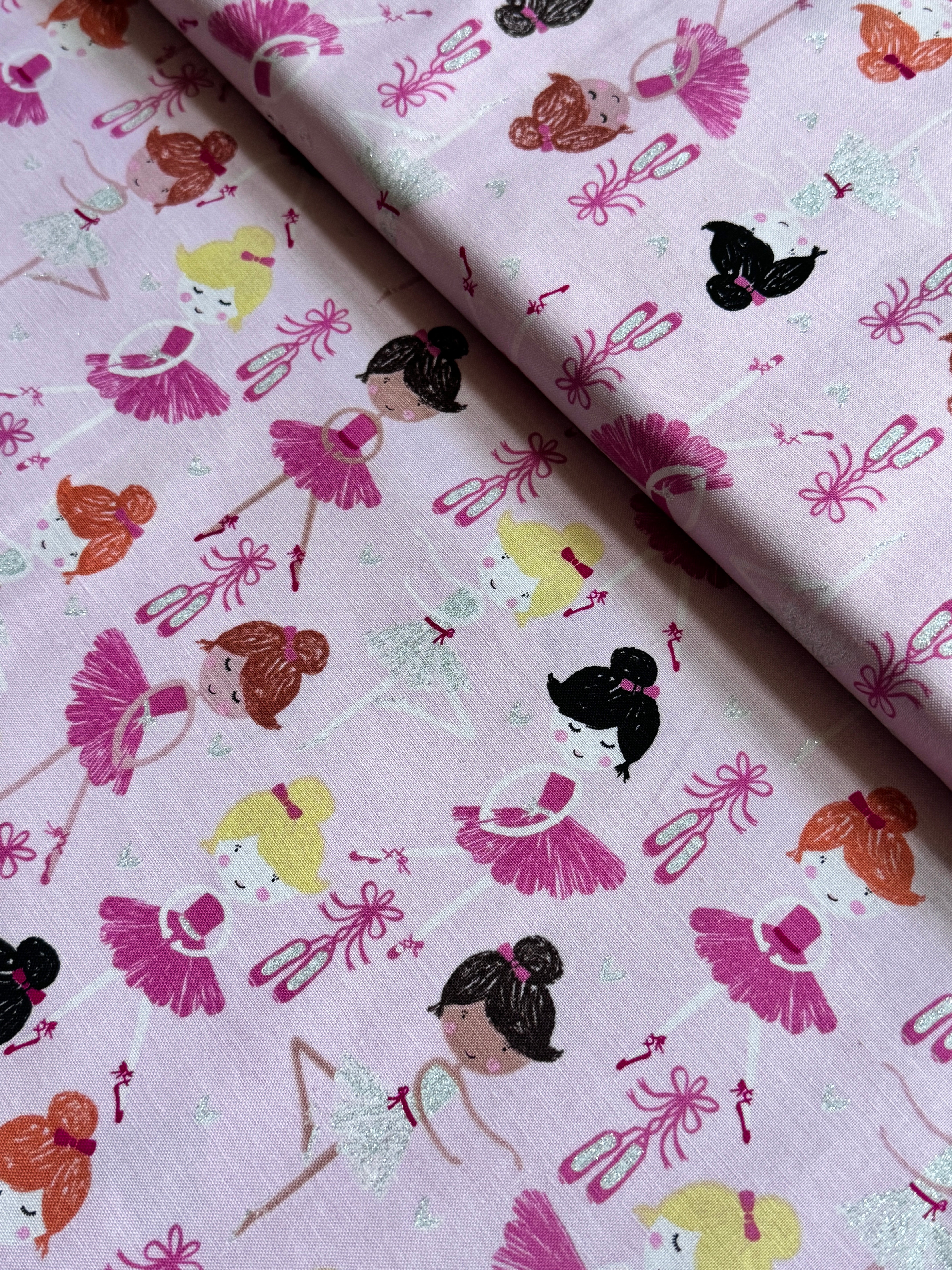 Pink cotton fabric featuring tossed ballerinas, tutus, ballet shoes, and silver glitter accents by Timeless Treasures.