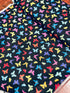 Colorful rainbow butterflies scattered on a black background fabric by Chong-A Hwang for Timeless Treasures.