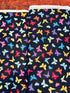 Colorful rainbow butterflies scattered on a black background fabric by Chong-A Hwang for Timeless Treasures.