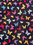 Colorful rainbow butterflies scattered on a black background fabric by Chong-A Hwang for Timeless Treasures.