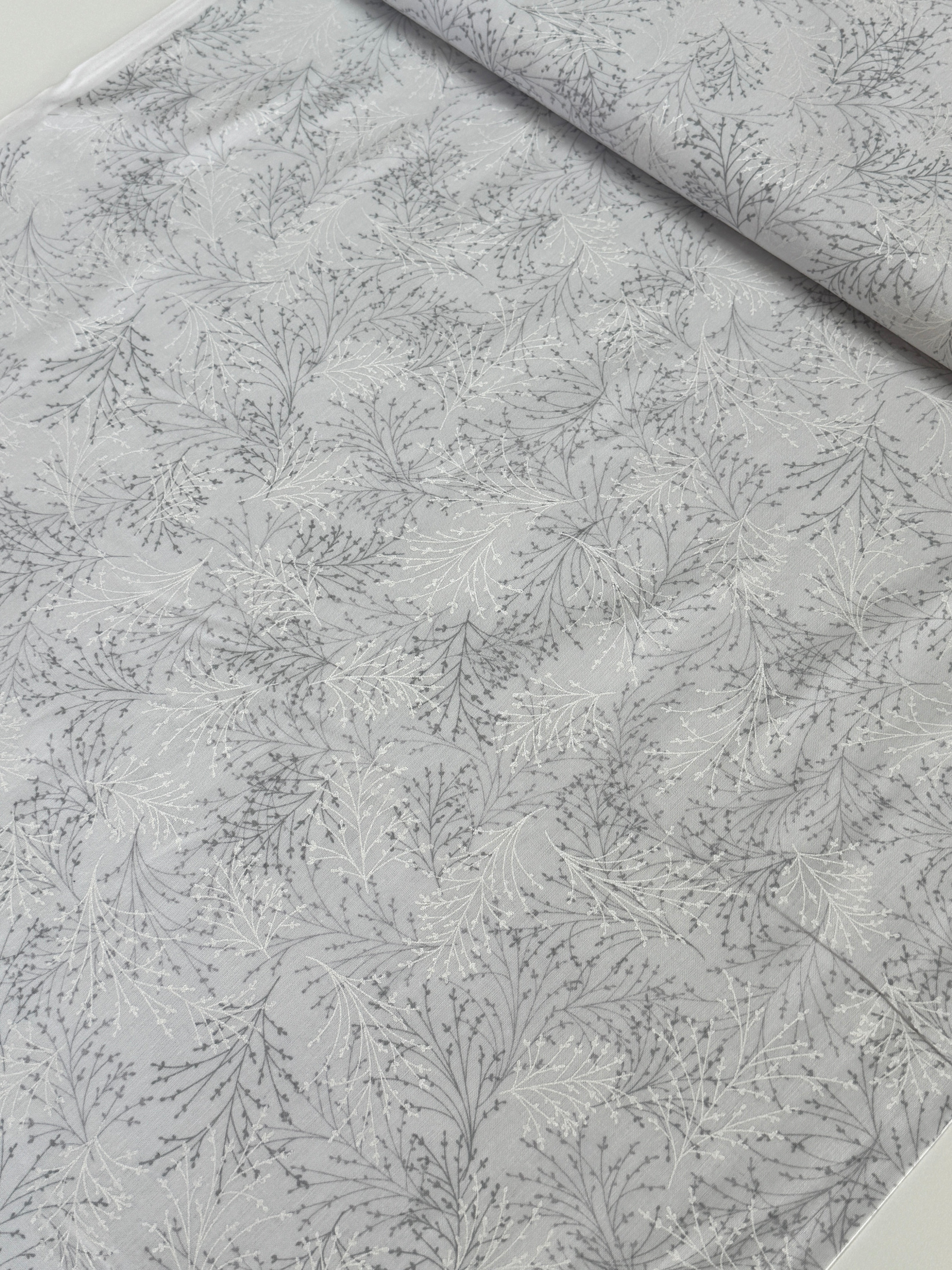 Pearl gray cotton fabric featuring delicate silver metallic botanical sprigs and branches by Kanvas Studio for Benartex.