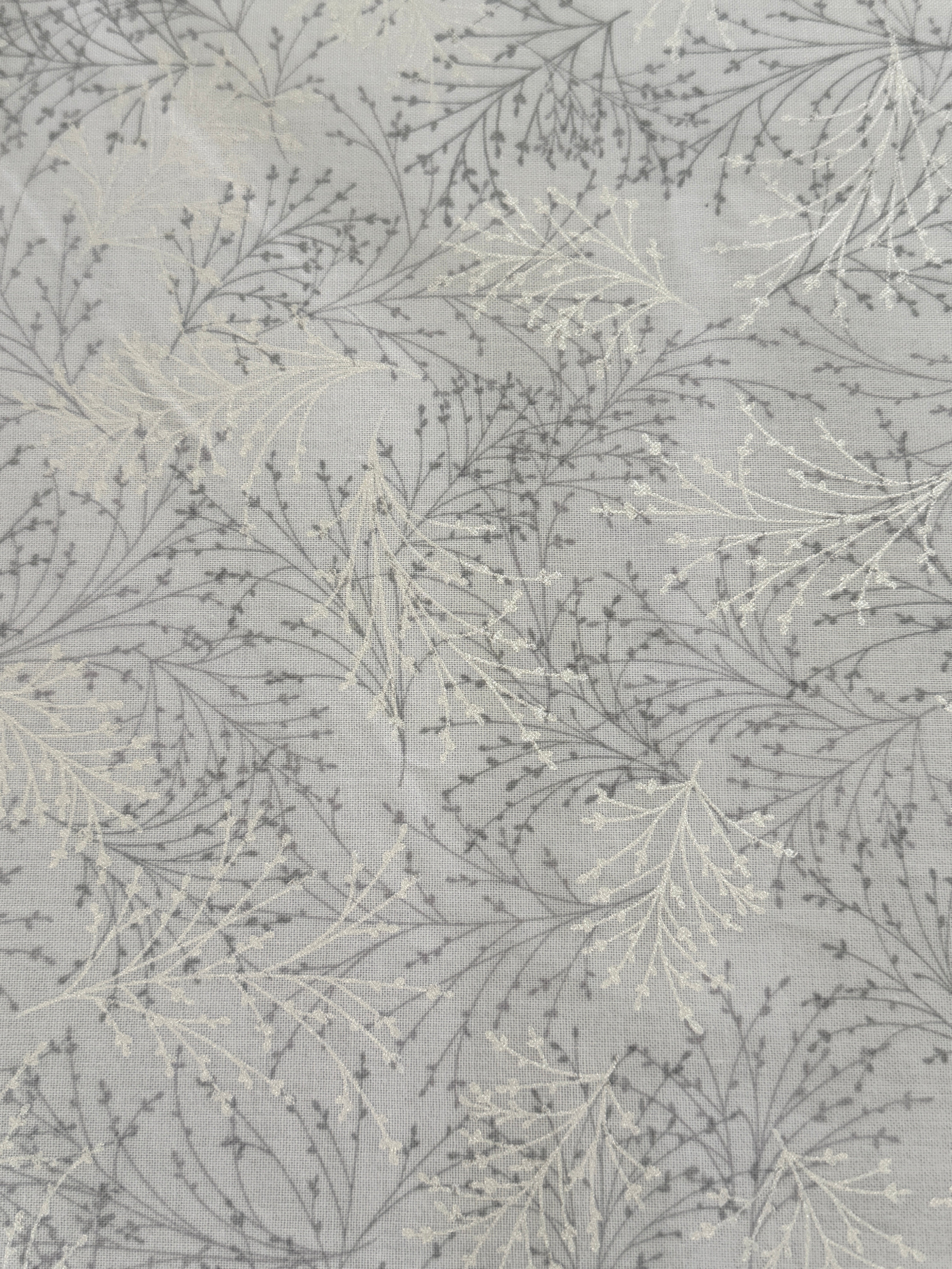 Pearl gray cotton fabric featuring delicate silver metallic botanical sprigs and branches by Kanvas Studio for Benartex.